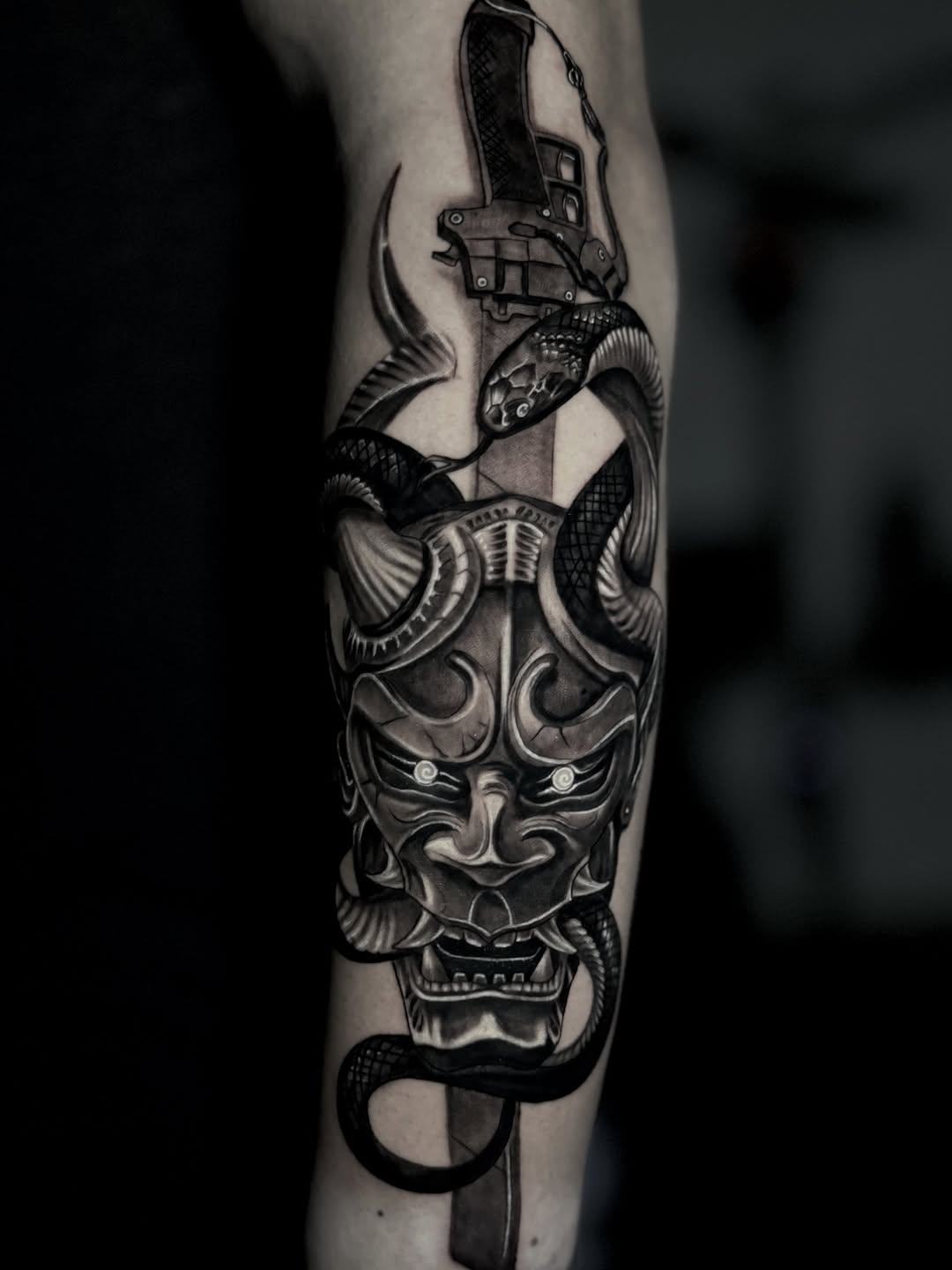 Oni mask with snake and sword Japanese tattoo on the forearm by Chris galvis, Charlotte, North Carolina