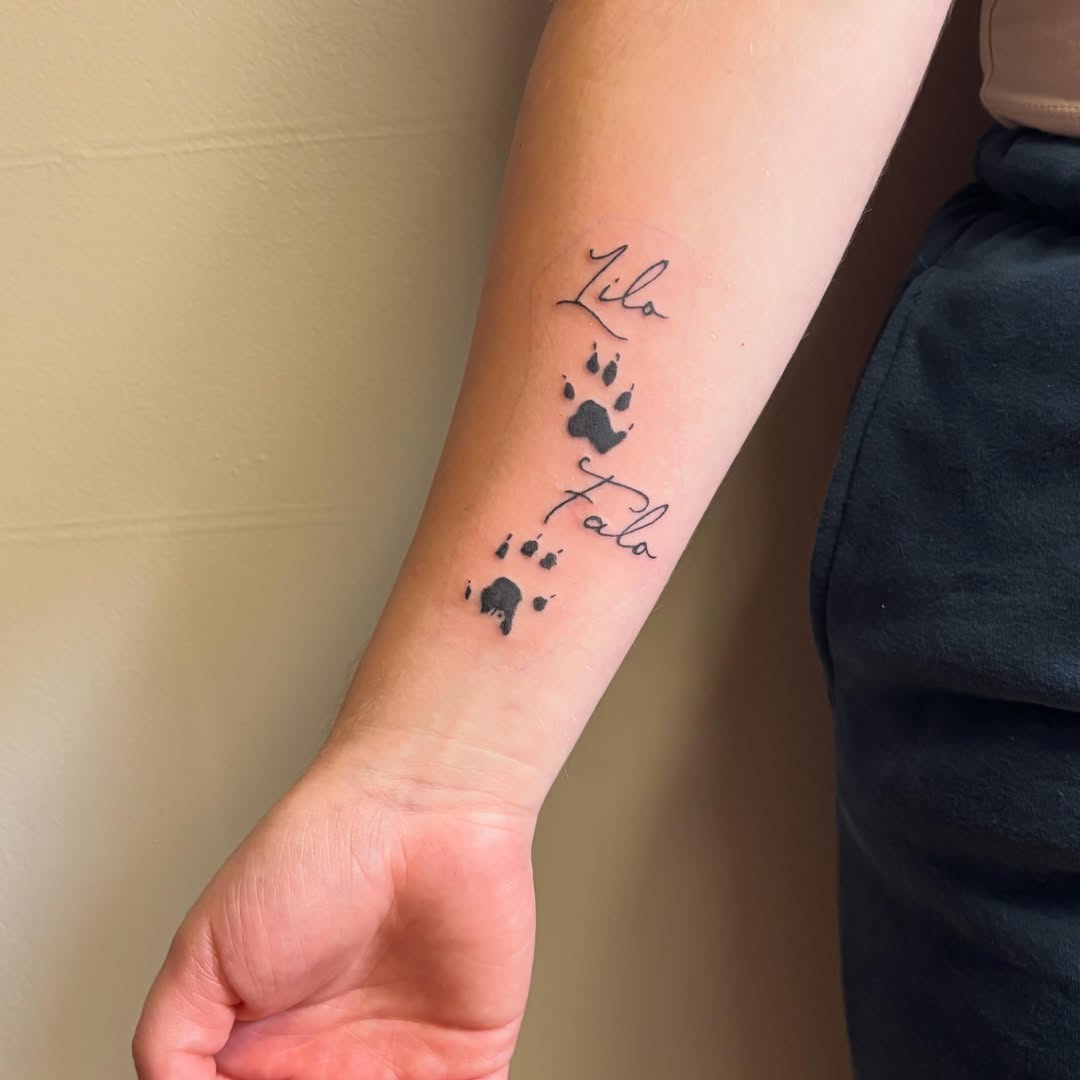 Paw prints and names dotwork tattoo on the forearm by Natalie Jade Shupe