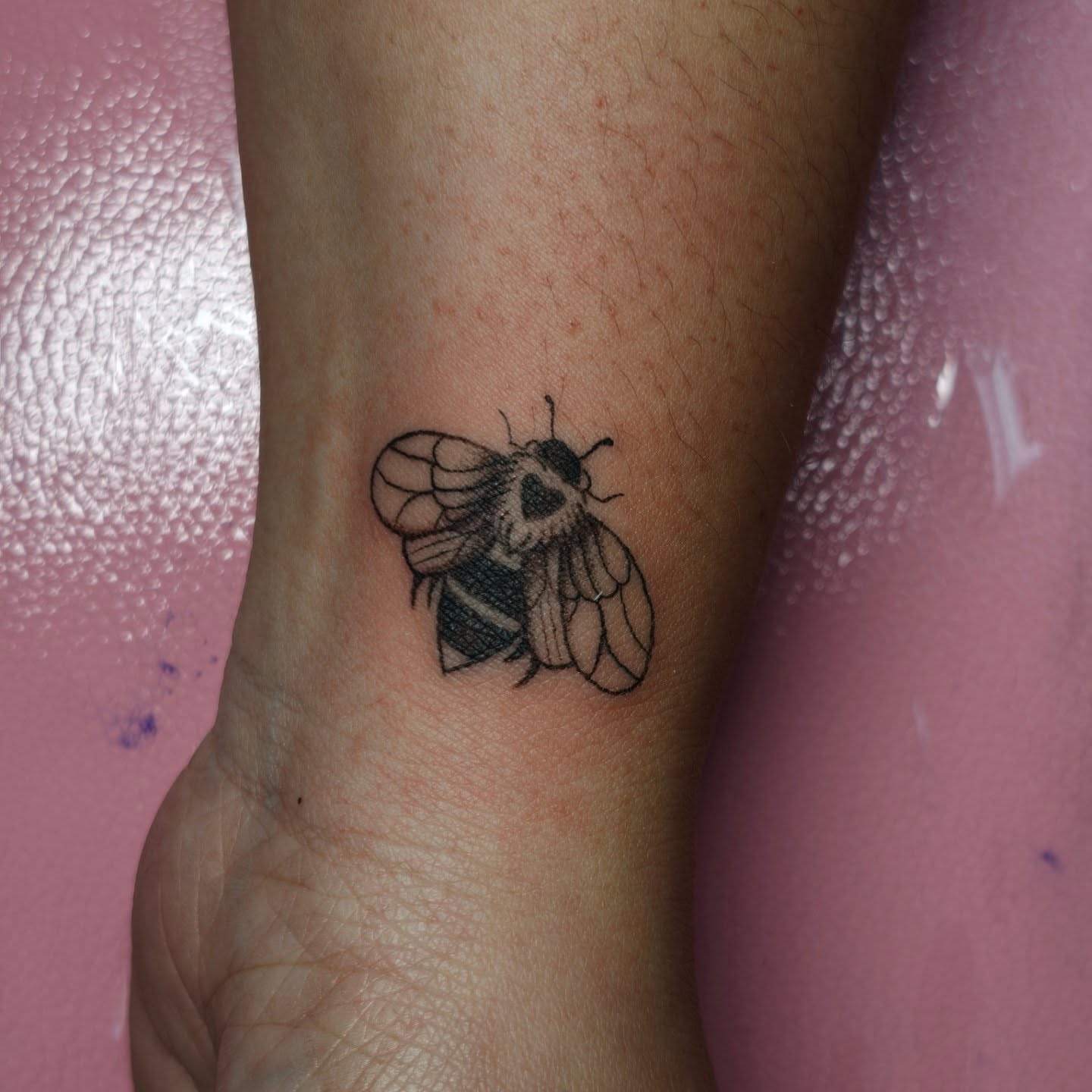 Bee black and grey tattoo on the forearm by Dani Sandoval, Anaheim, California