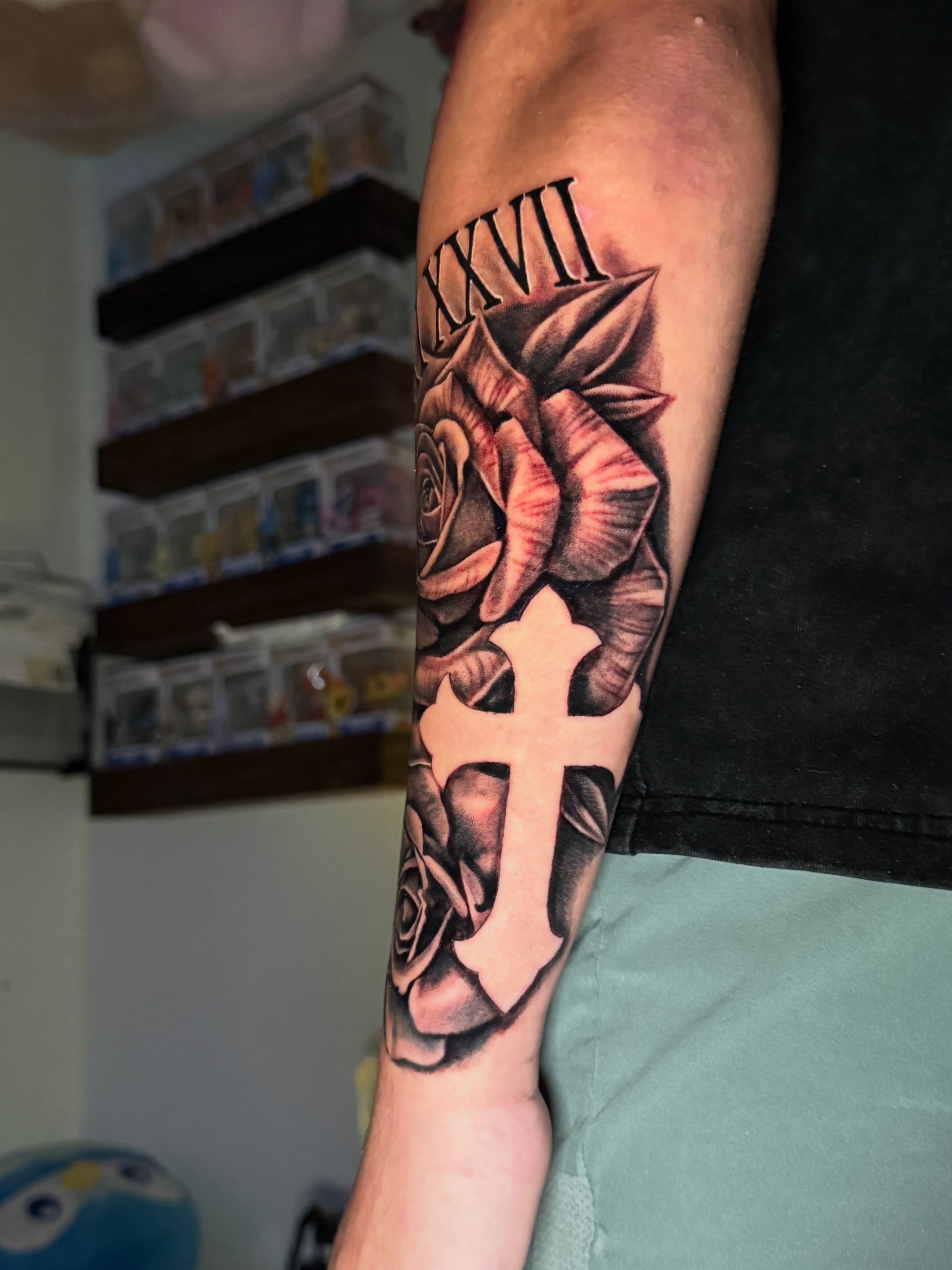 Cross and roses realism tattoo on the forearm by Quentin Stevenson, Slidell, Louisiana