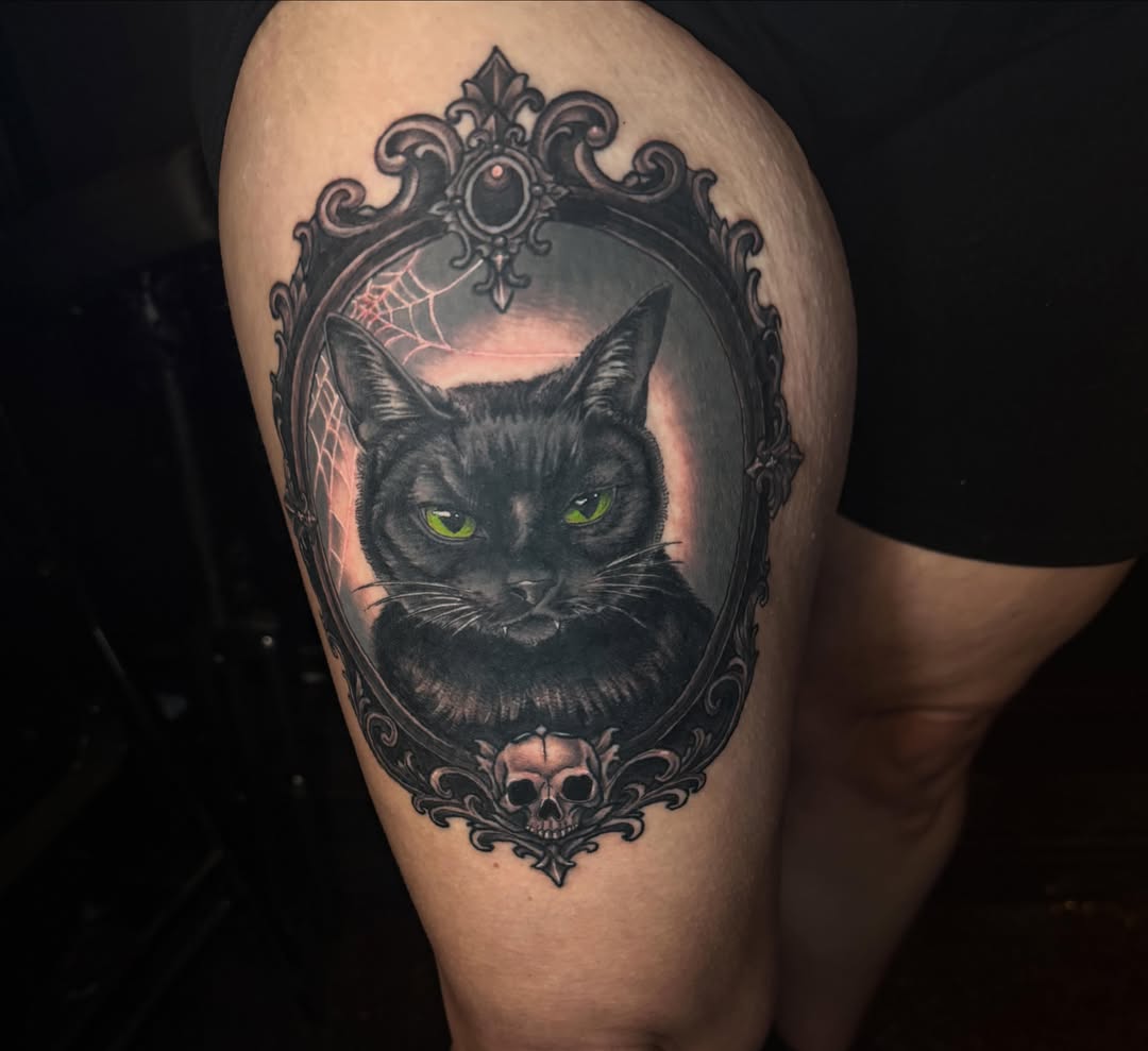 Black cat dark realism tattoo on the thigh by Shelby Warren