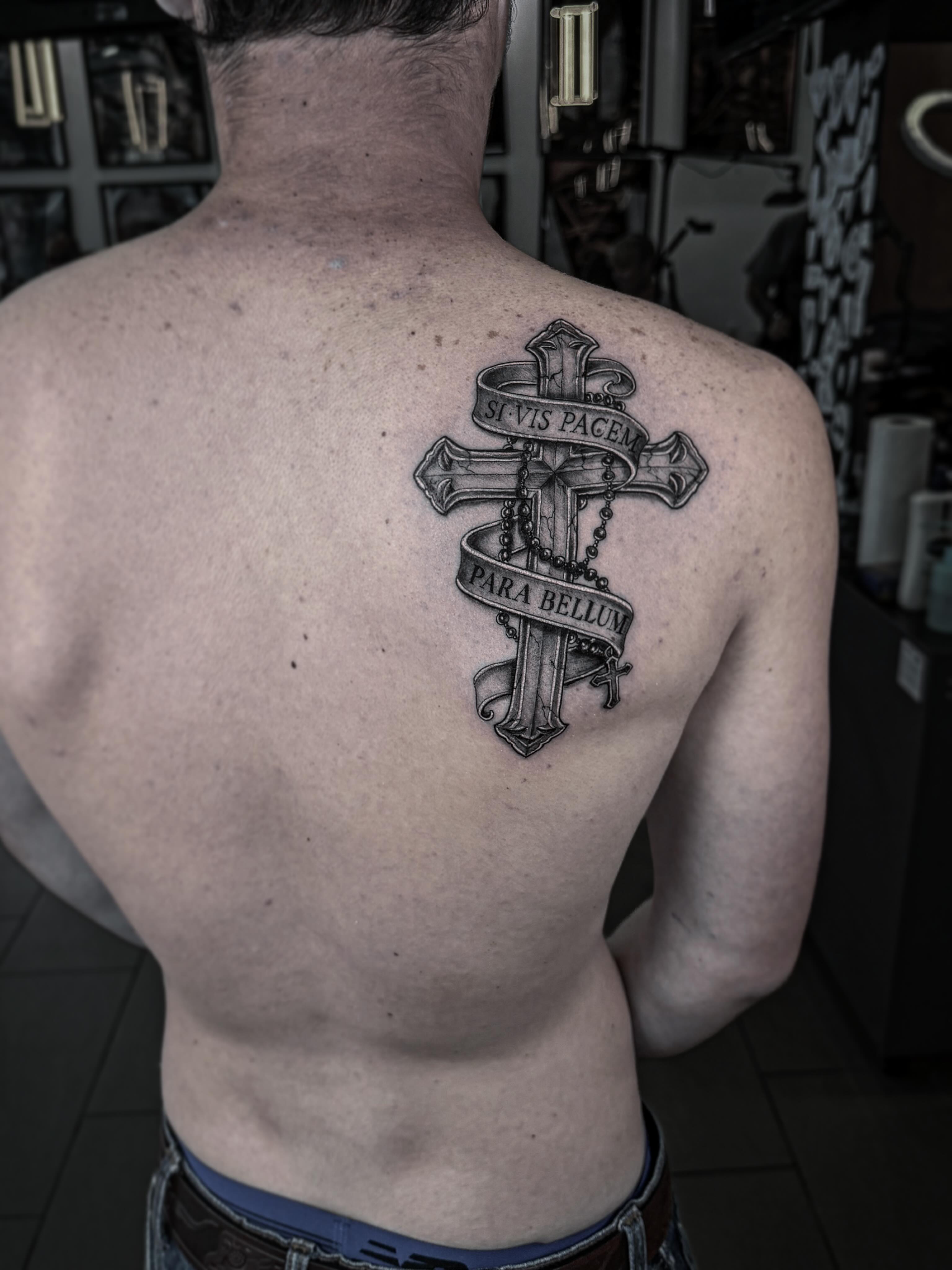 Cross with banner black and grey tattoo on the back by Tattoo Ottawa