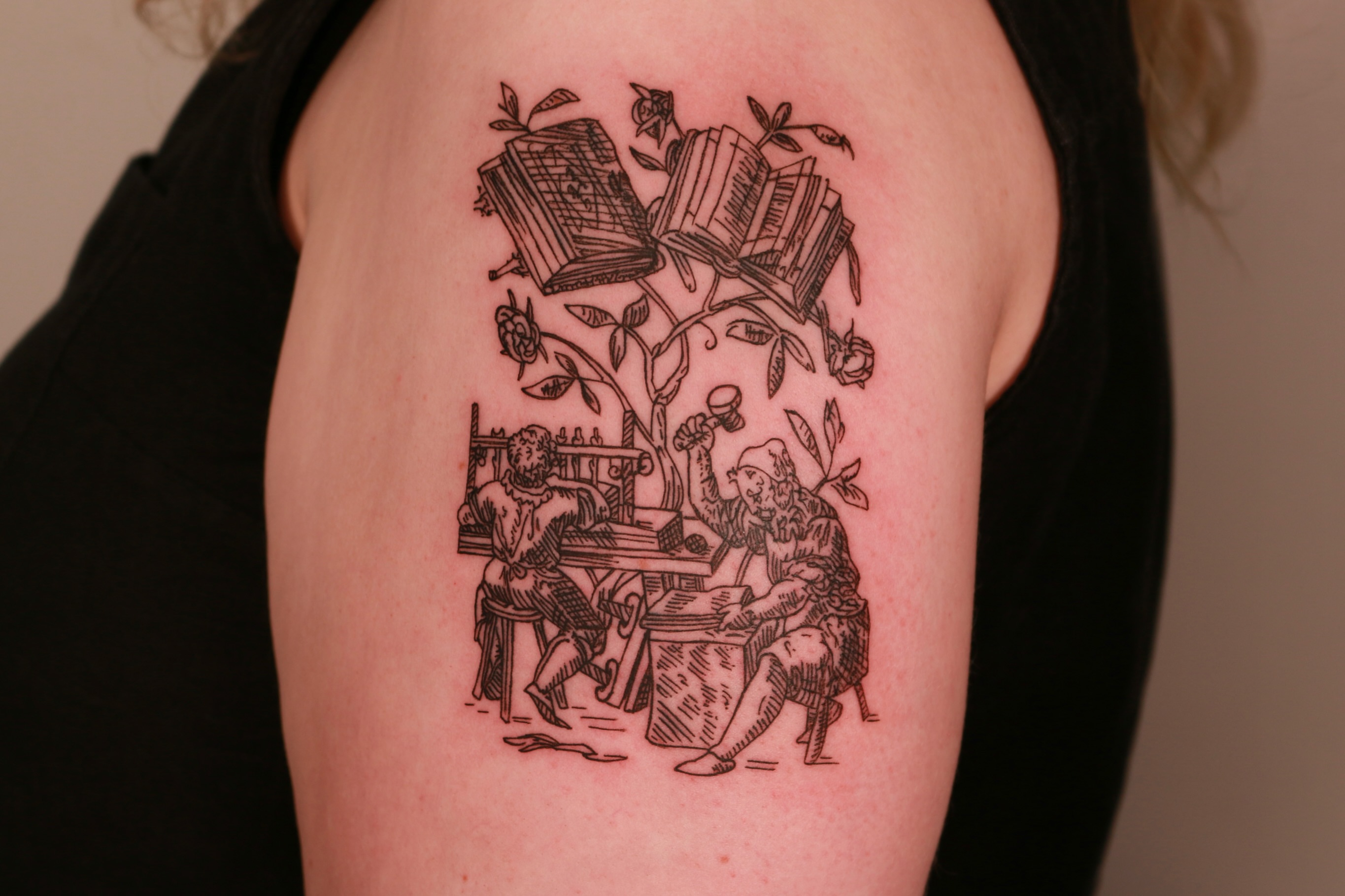 Bookshelf and figures black and grey tattoo on the shoulder by Mike