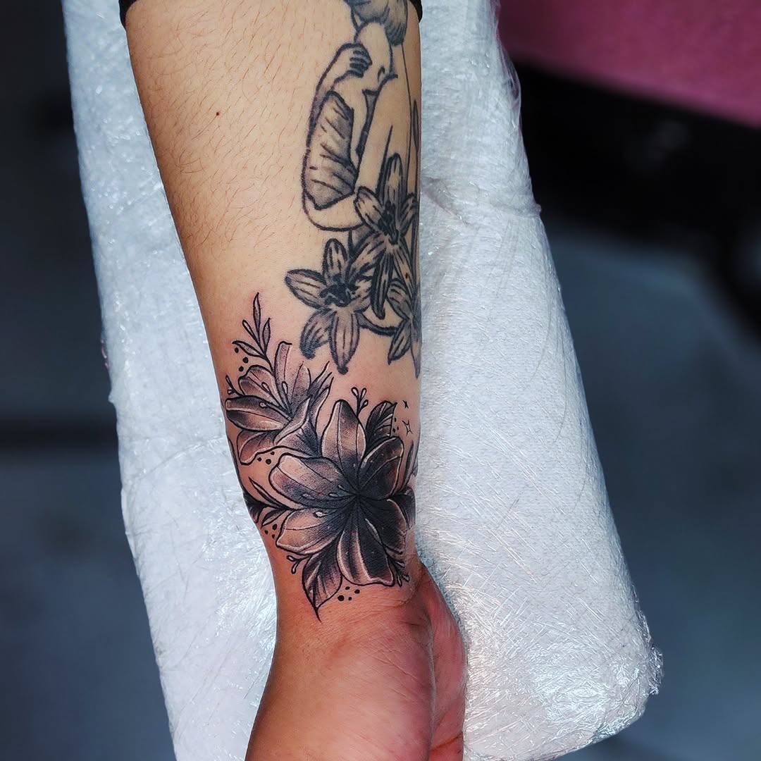 Flowers and figure fine line tattoo on the forearm by Kai_Tattoo