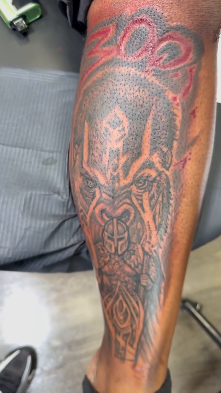 Gorilla face with ornate patterns realism tattoo on the calf by Shine Jefferson, Memphis, Tennessee