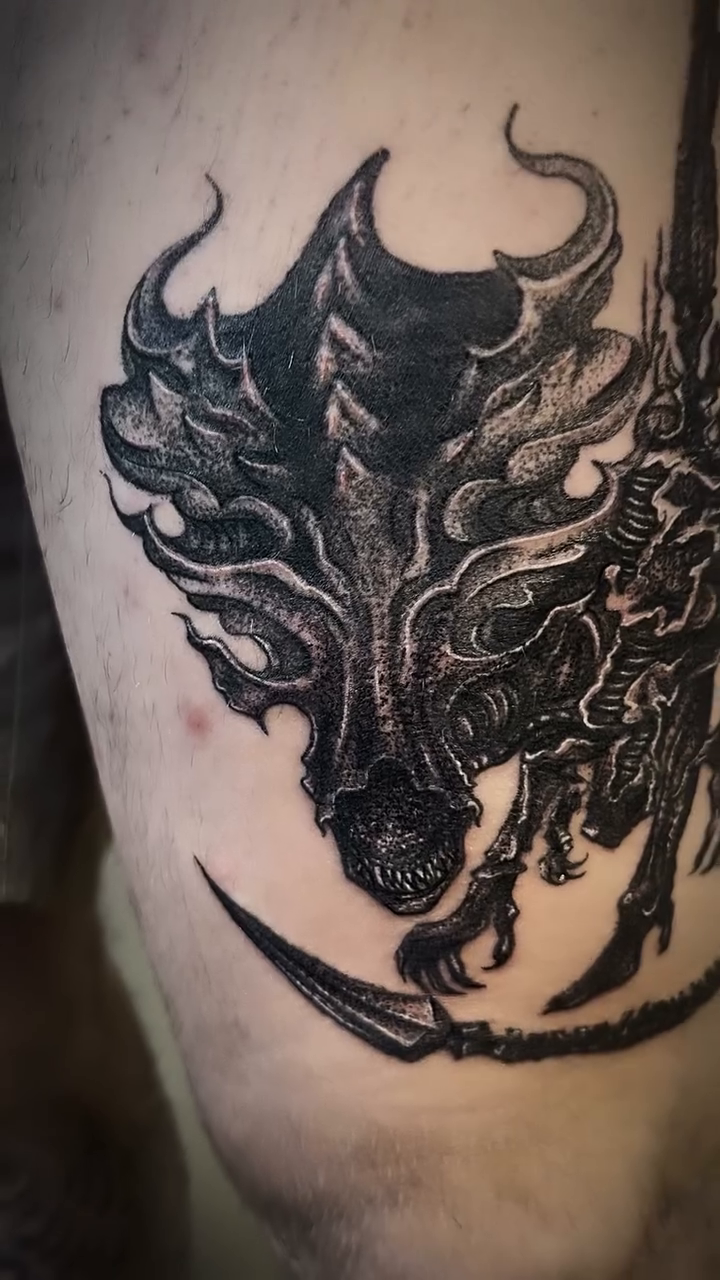 Dragon head and body realism tattoo on the leg by Nikki Ward