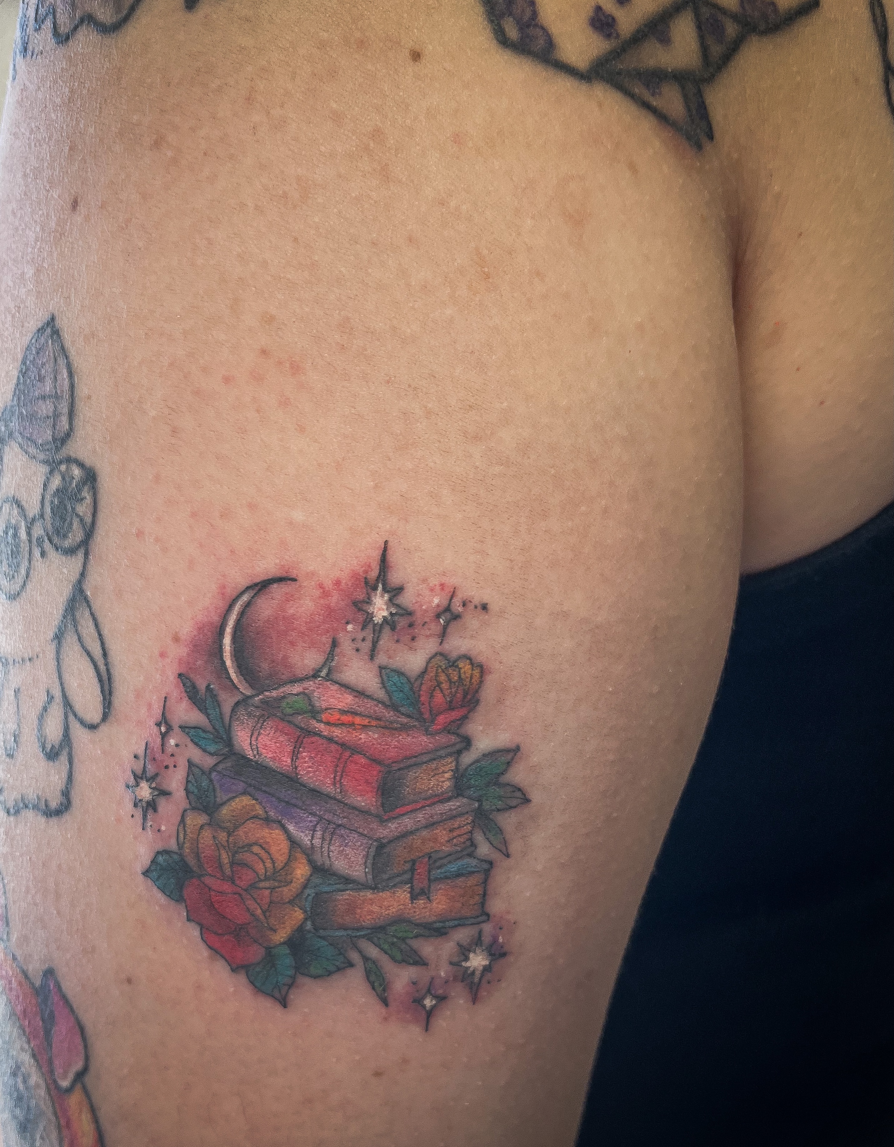 Stacked books new school tattoo on the shoulder by Janelle Cuba