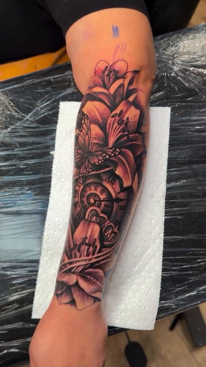 Floral and butterfly sleeve fine line tattoo on the forearm by Terrence jones