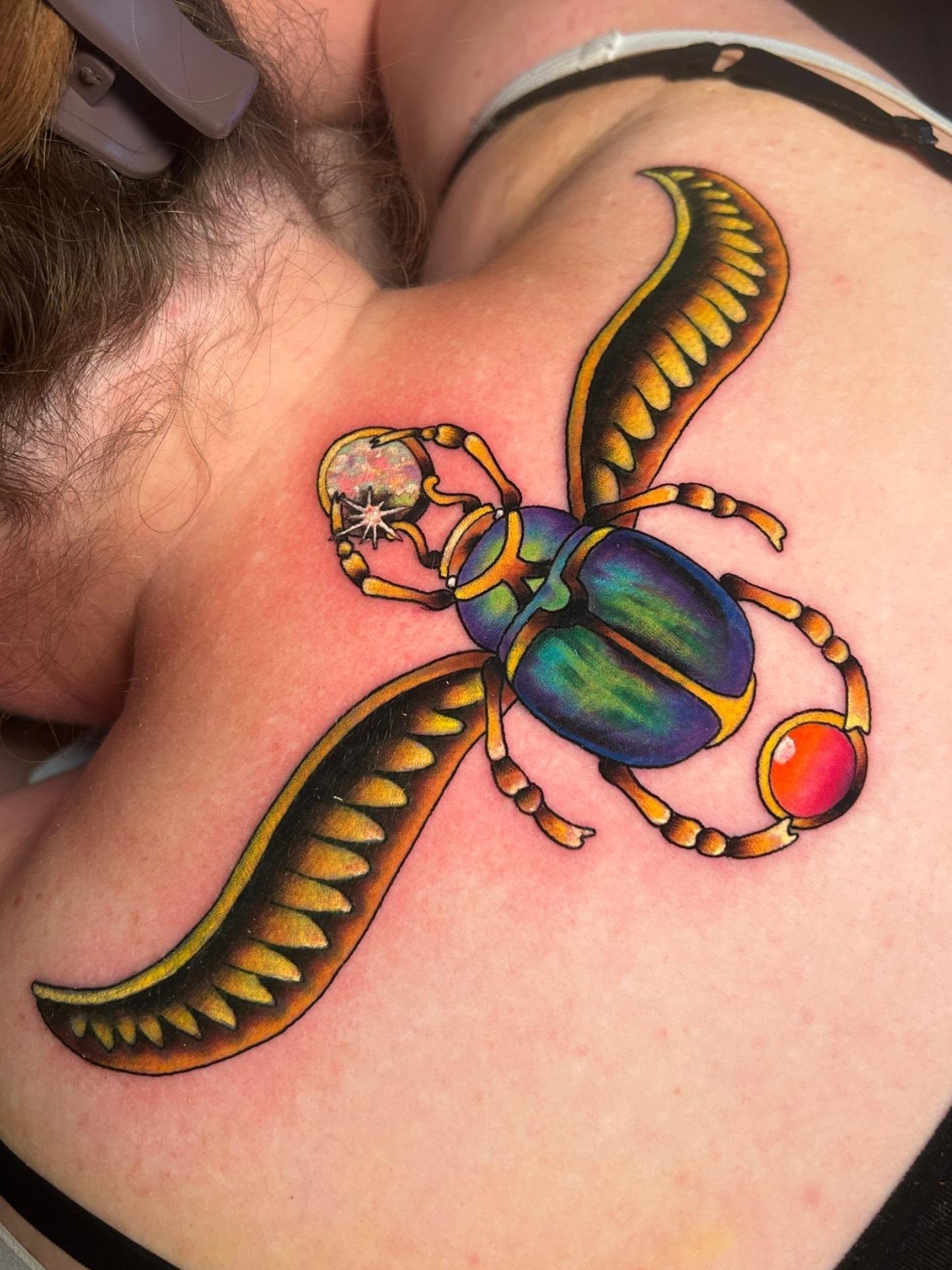 Scarab beetle new school tattoo on the shoulder by Chloe Marie