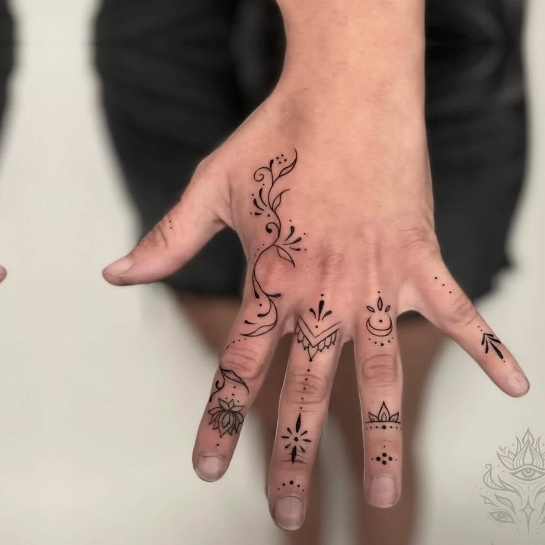 Ornamental vine and symbols ornamental tattoo on the hand by Donavon Batz