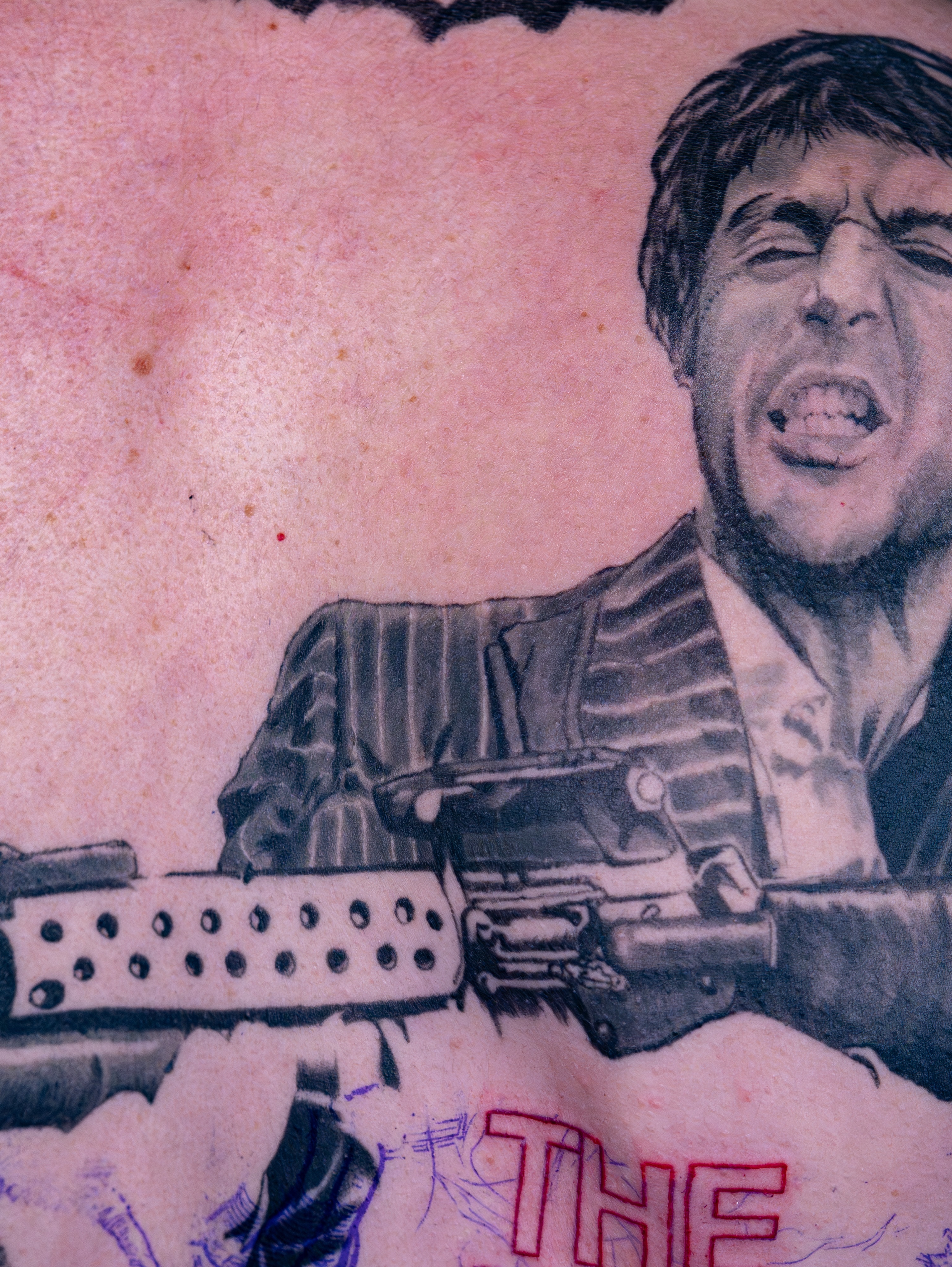 Gun and man black and grey tattoo on the forearm by Simon Pouliot