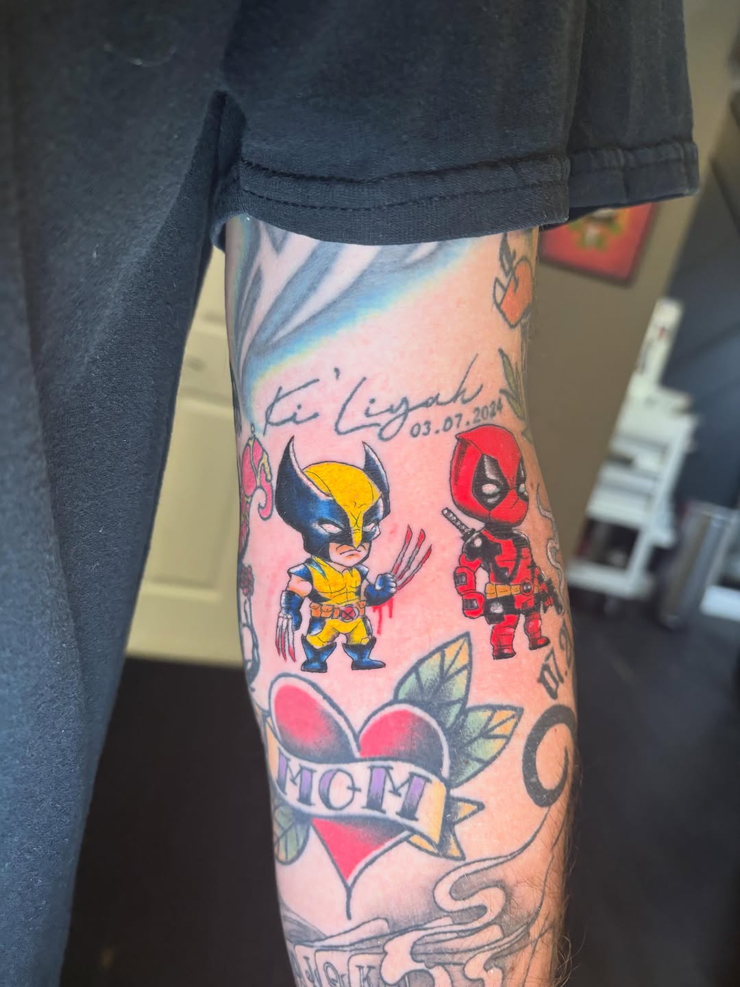 Wolverine and Deadpool characters tattoo on the forearm by Aubri Aunna