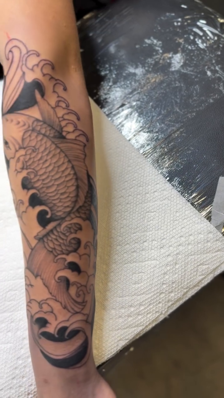 Koi fish and waves Japanese tattoo on the forearm by WhoisLaineyTattoos