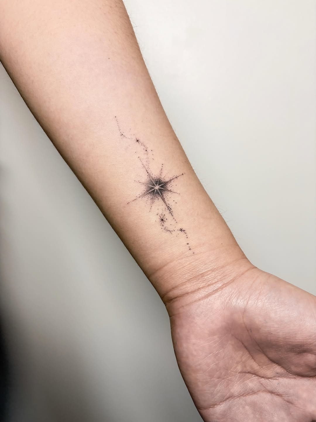 Star compass sketch tattoo on the forearm by Jinz