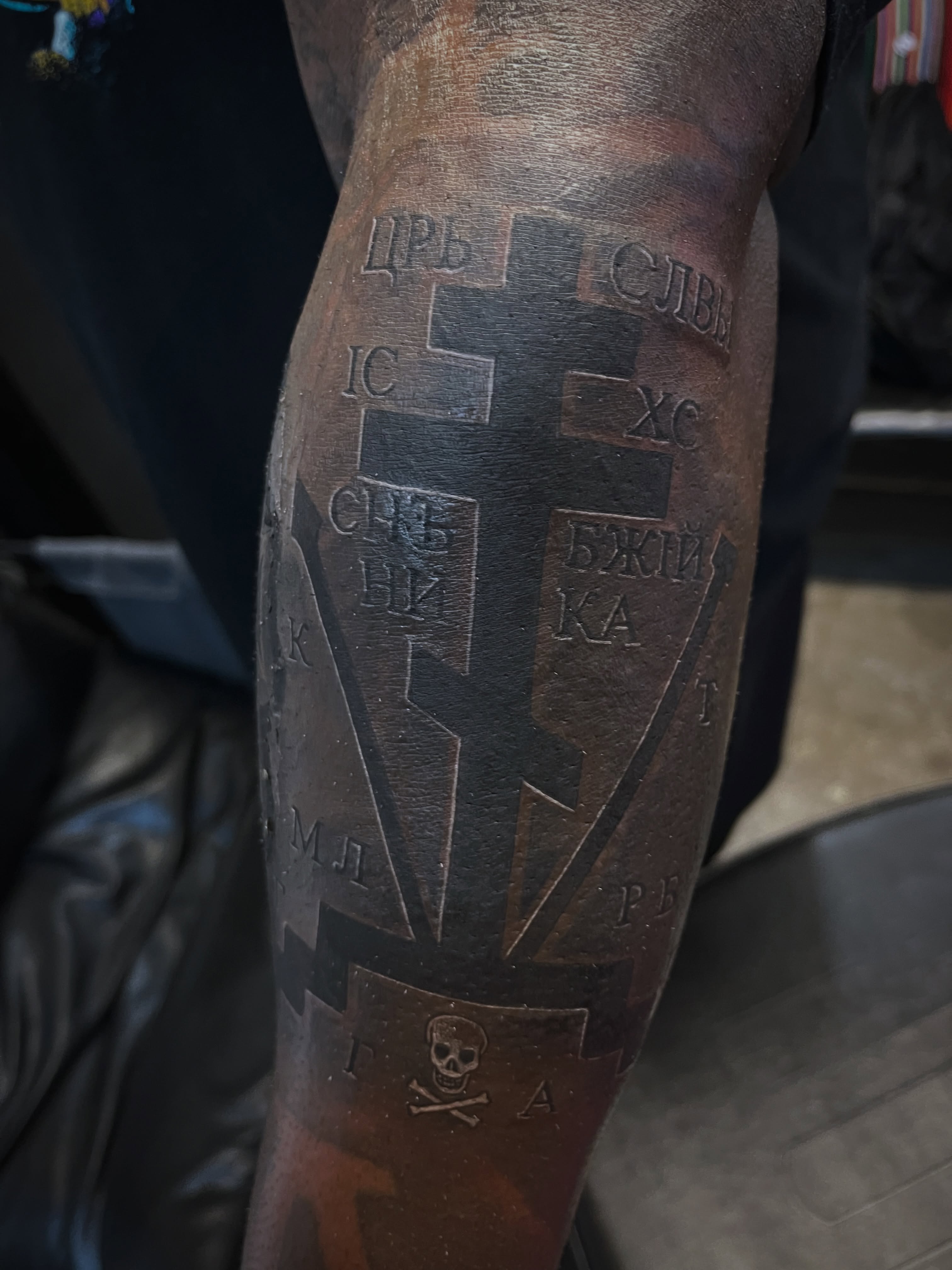 Crosses and Cyrillic text black and grey tattoo on the forearm by Kwete Tatuajes