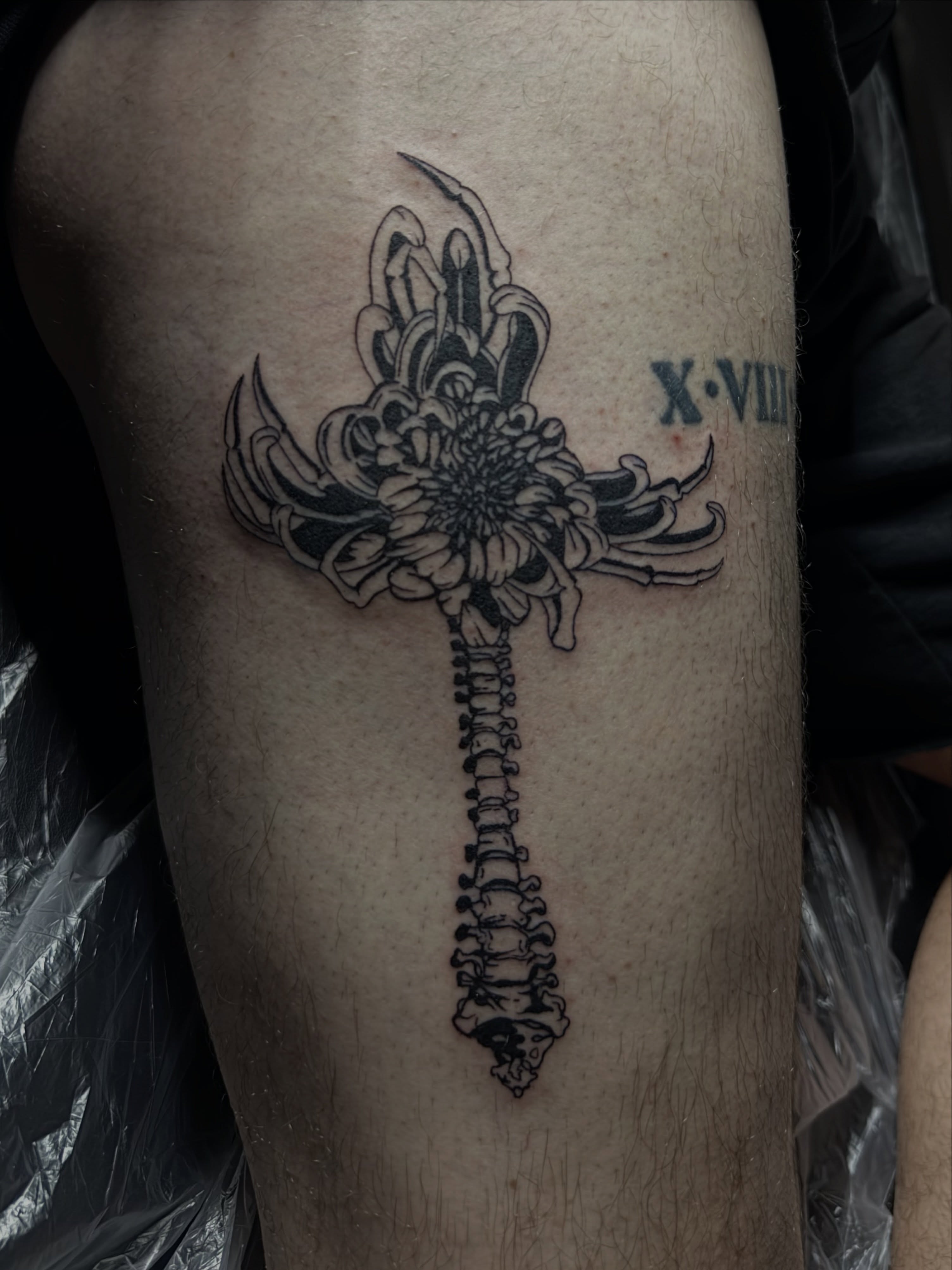 Cross with floral elements geometric tattoo on the forearm by Casper Tattoos Toronto