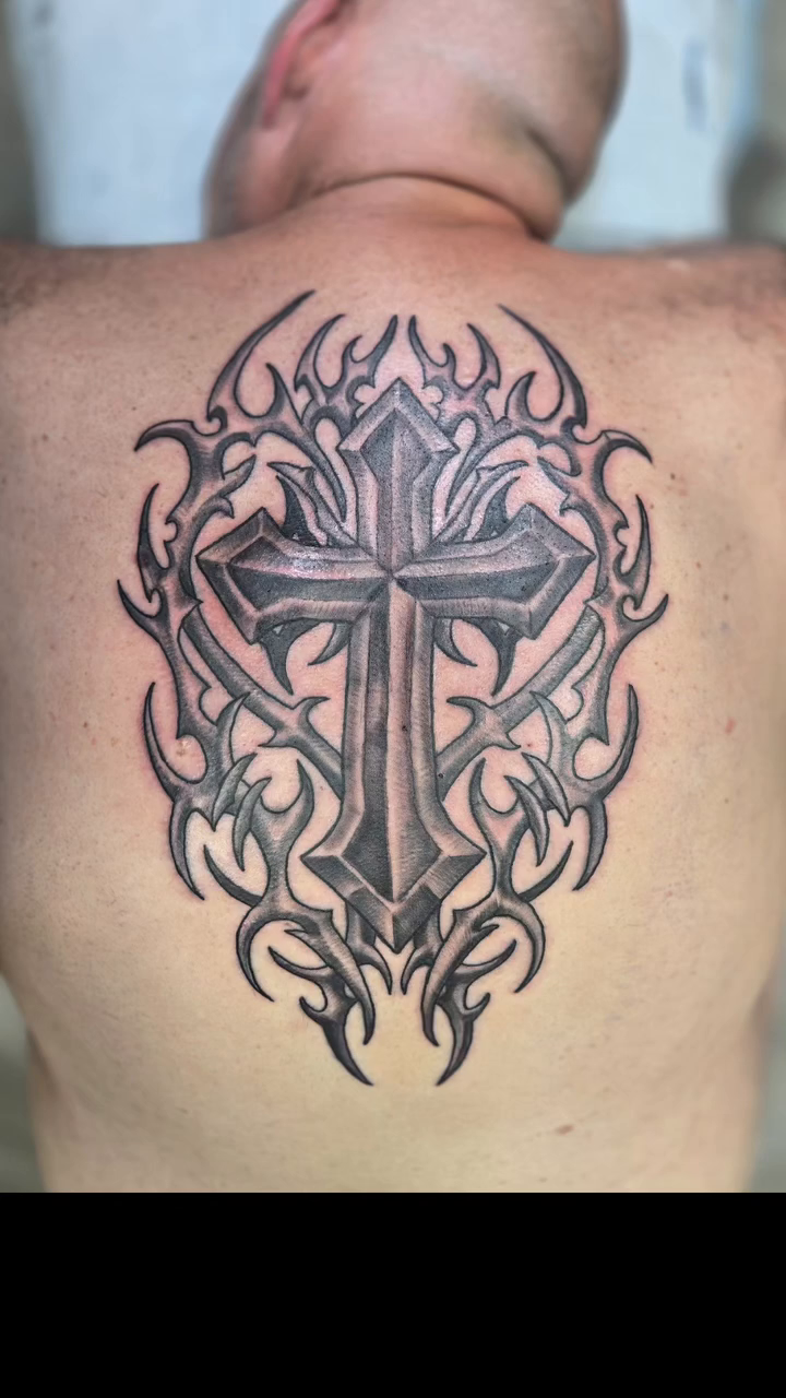 Cross with tribal elements tribal tattoo on the back by Karen Cain