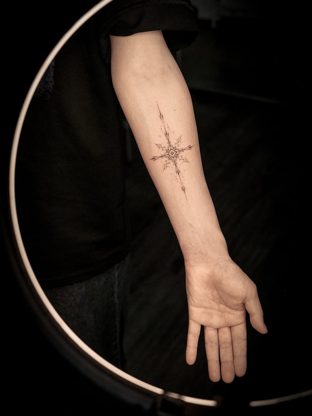 Geometric starburst sketch tattoo on the forearm by Easy