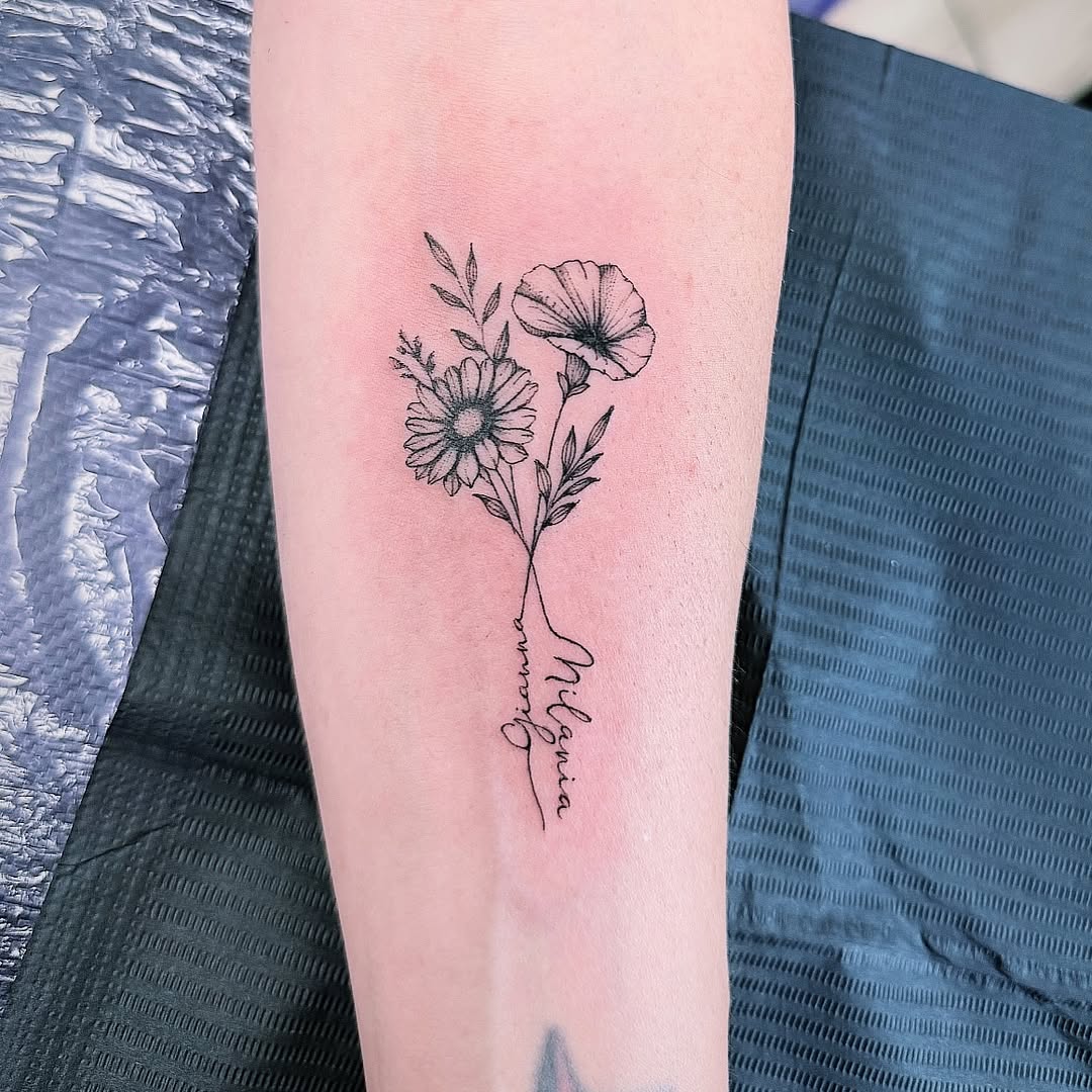 Flowers and script fine line tattoo on the forearm by Ink About Me - Amanda’s Fine Lines