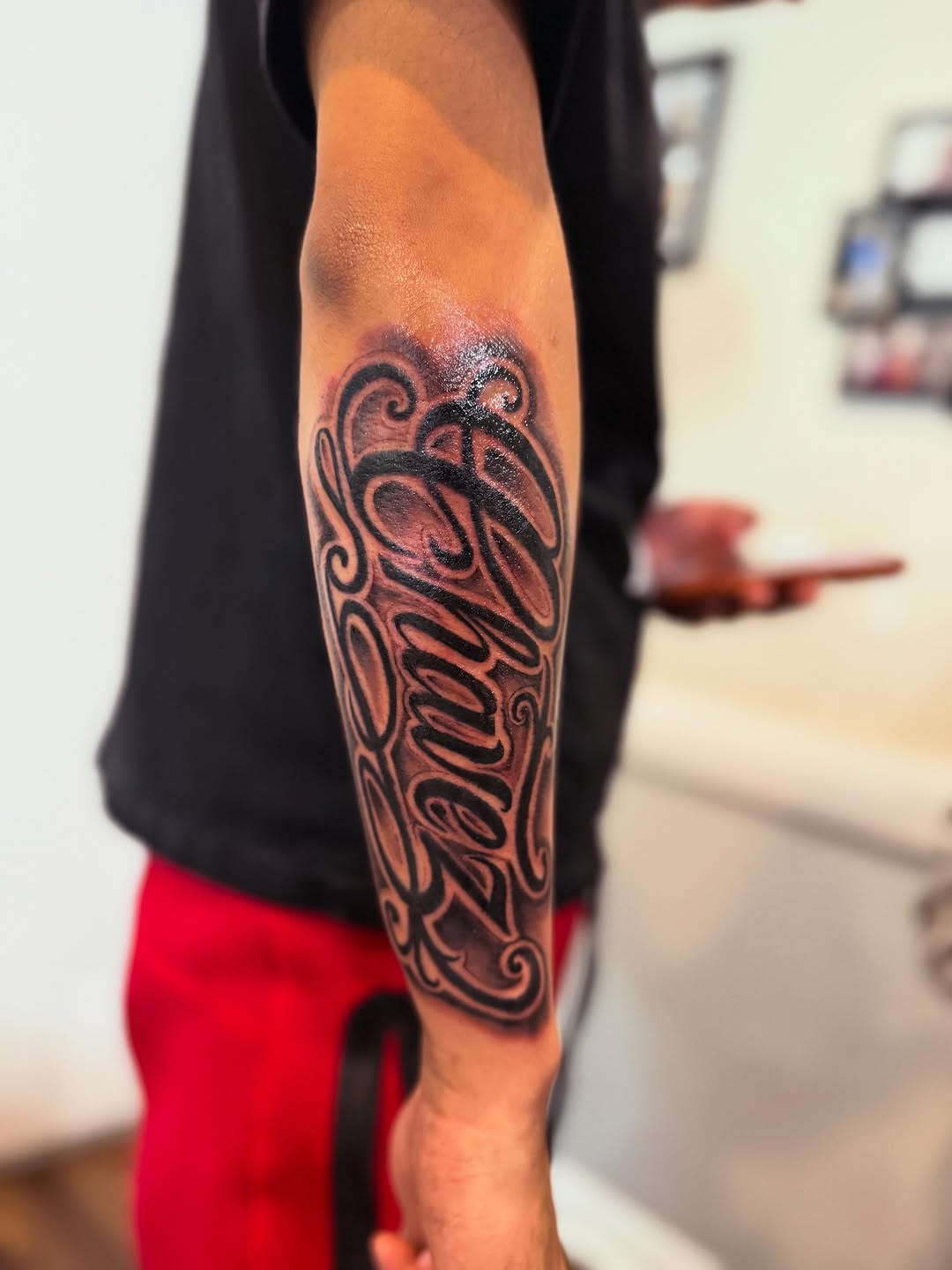 Script lettering lettering tattoo on the forearm by Tattoomobile