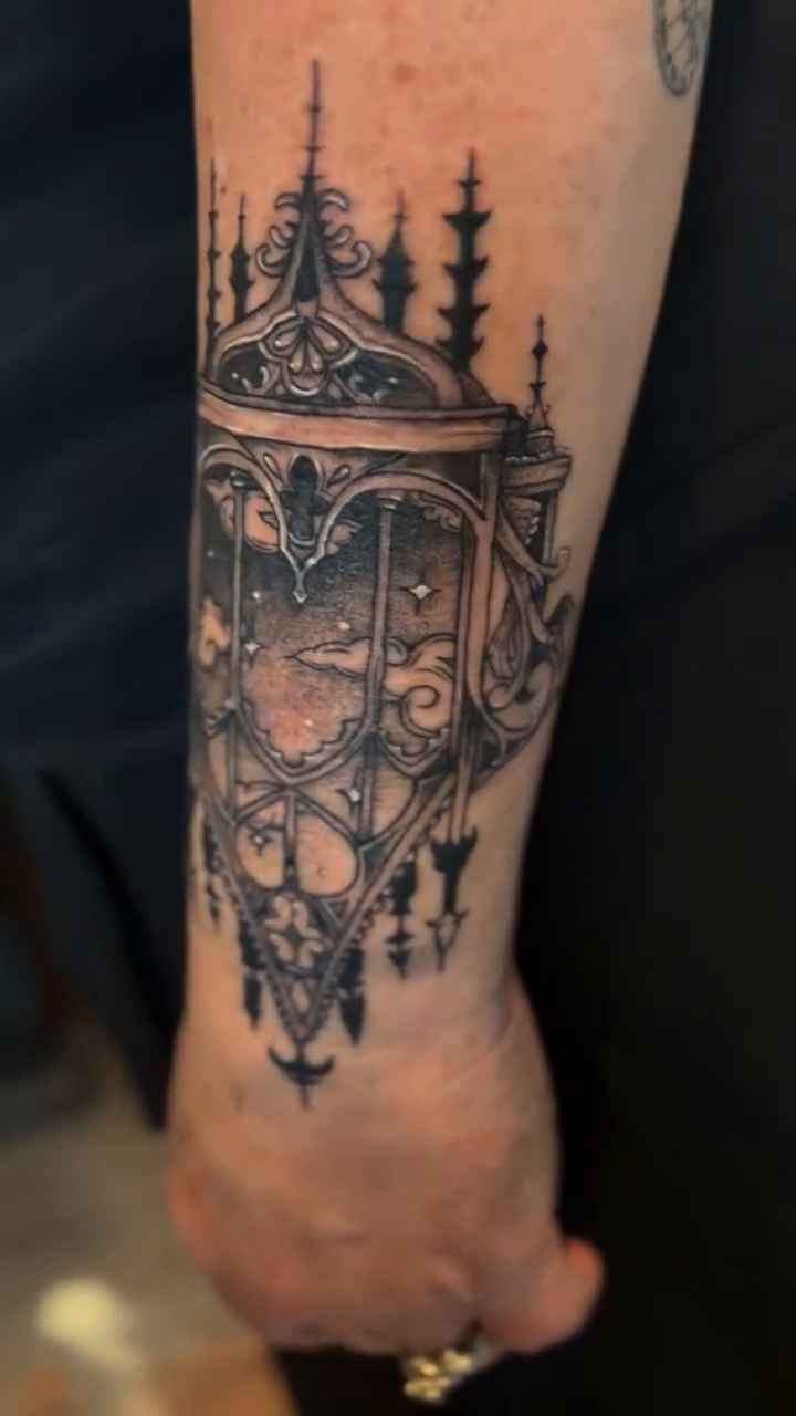 Gothic cathedral window with celestial elements dark art tattoo on the forearm by destany aguilera, Davenport, Iowa