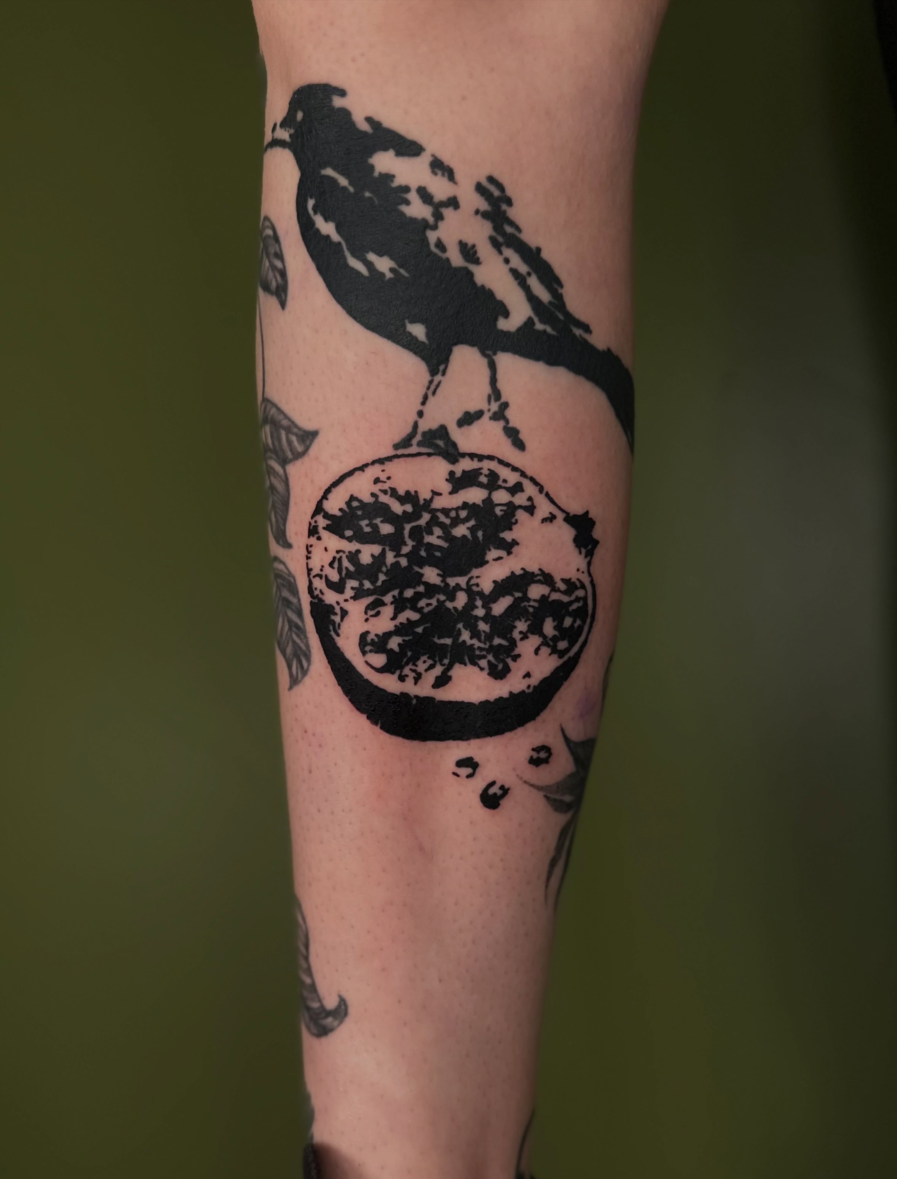Bird and fruit black and grey tattoo on the forearm by Nikolas Tapio Aatos Mäkelä