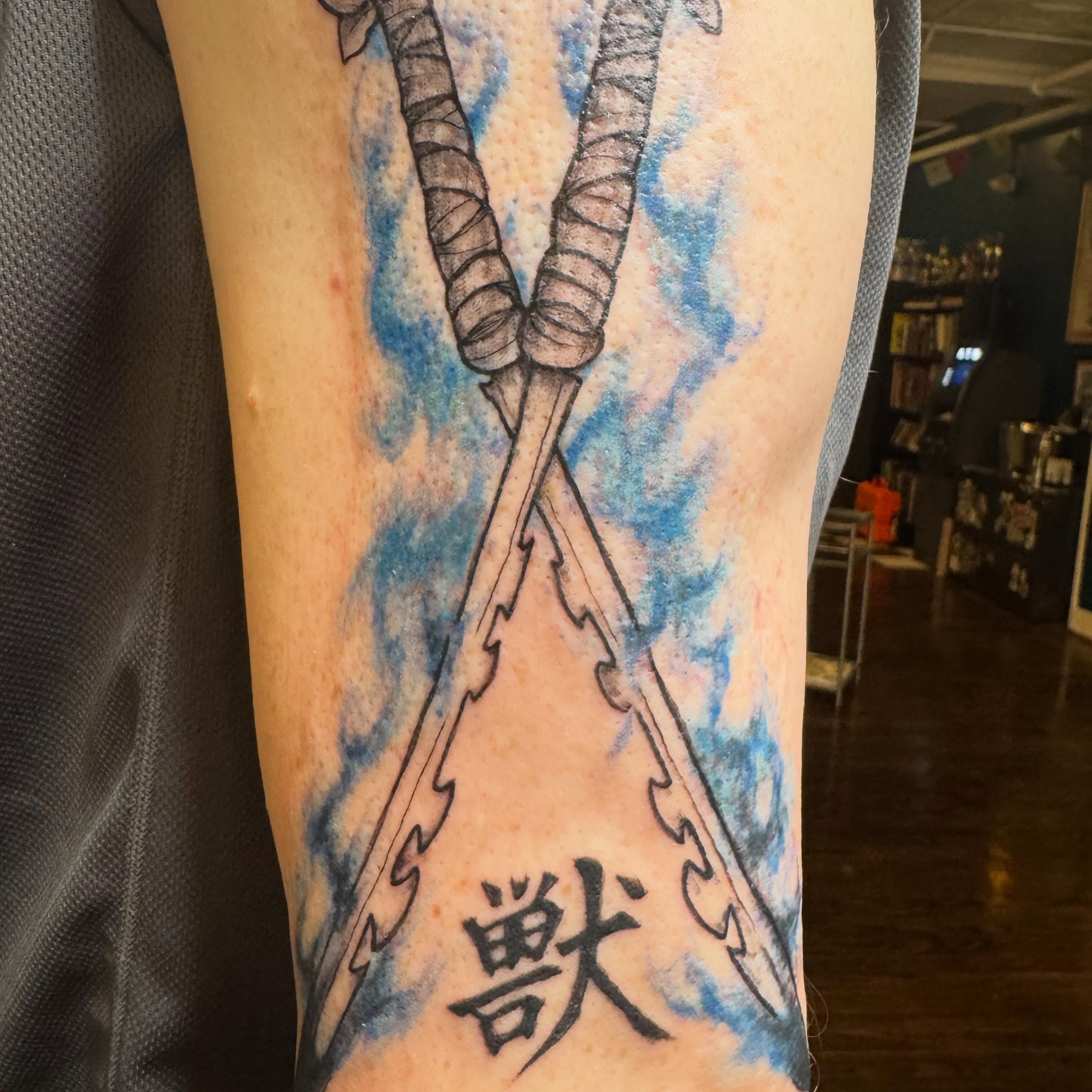 Crossed swords watercolor tattoo on the forearm by Bob Lindell Tattoos