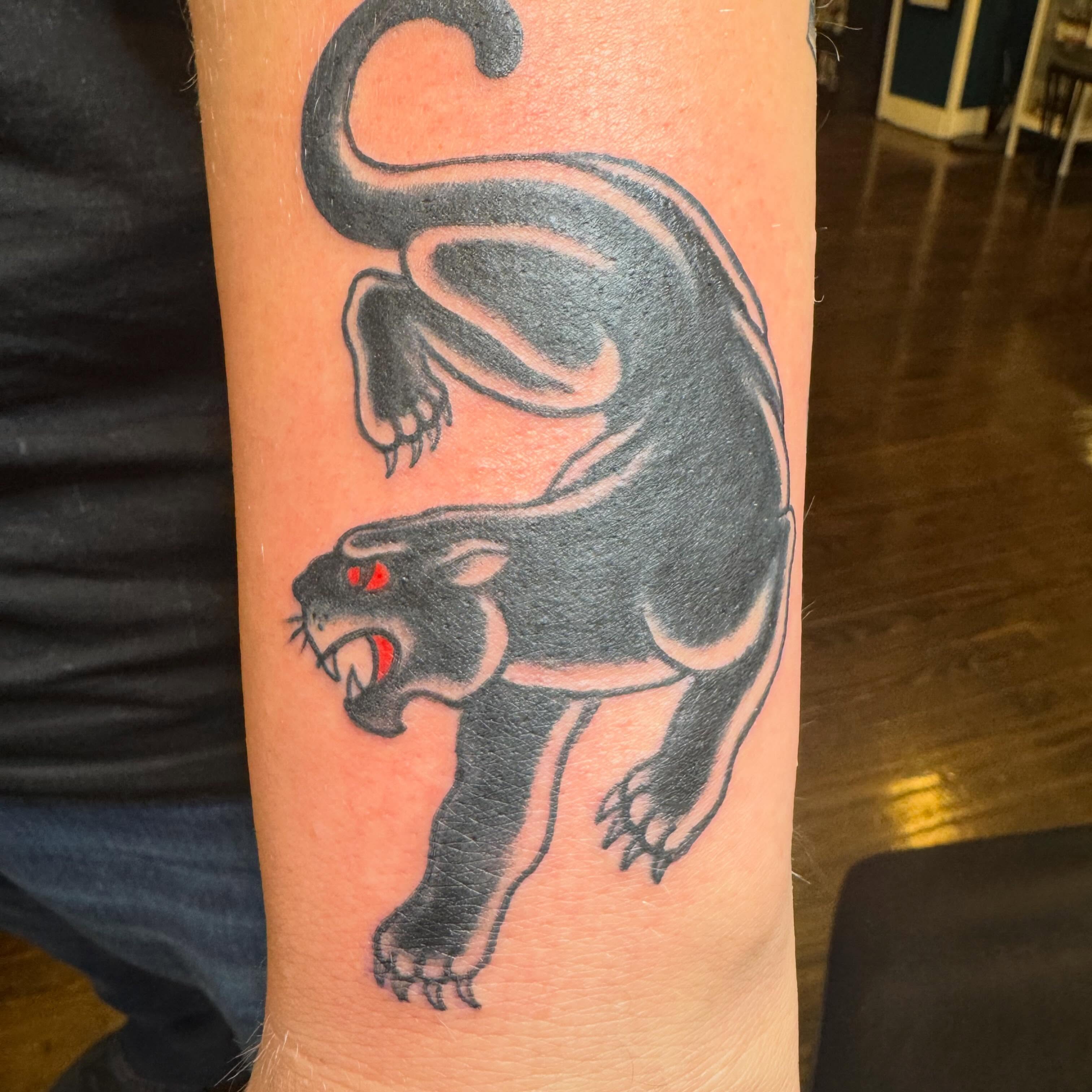 Panther black and grey tattoo on the forearm by Bob Lindell Tattoos