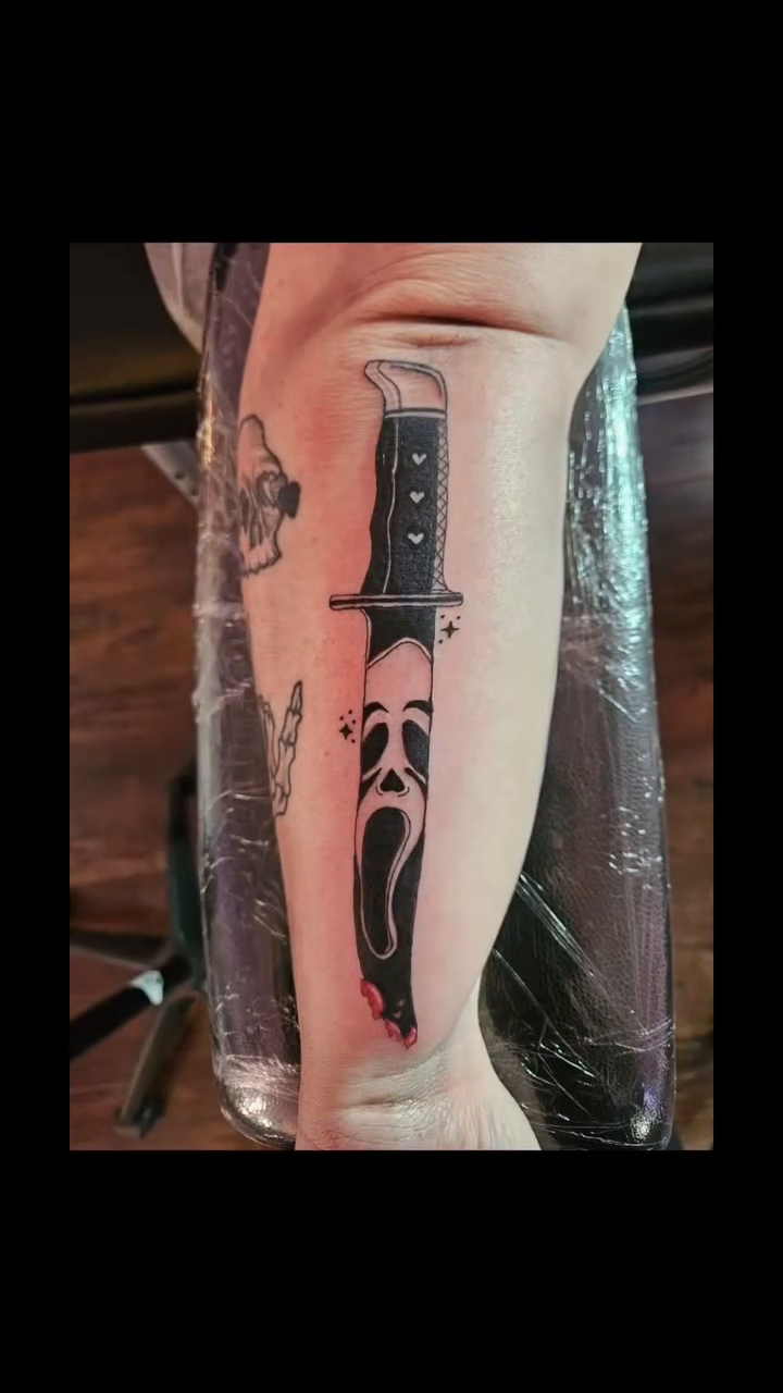 Ghostface knife tattoo realism tattoo on the forearm by Mischief π€