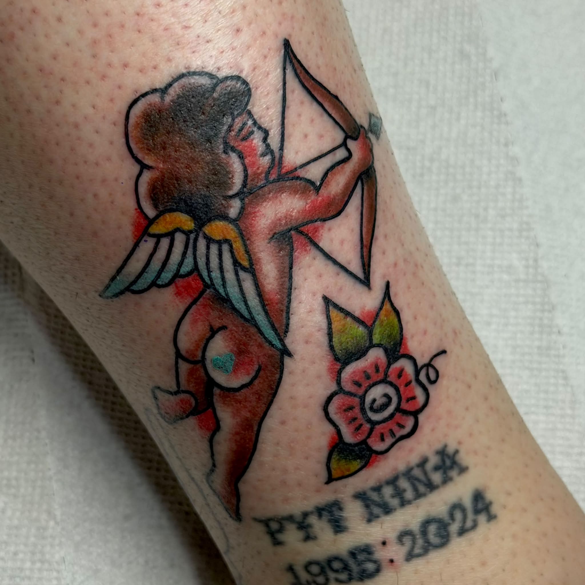 Cherub with bow American traditional tattoo on the forearm by Kenneth Prince