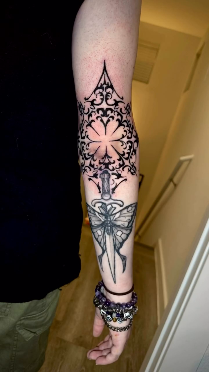 Ornamental dagger with butterfly ornamental tattoo on the upper arm by James ⚡️ Tattoo Artist
