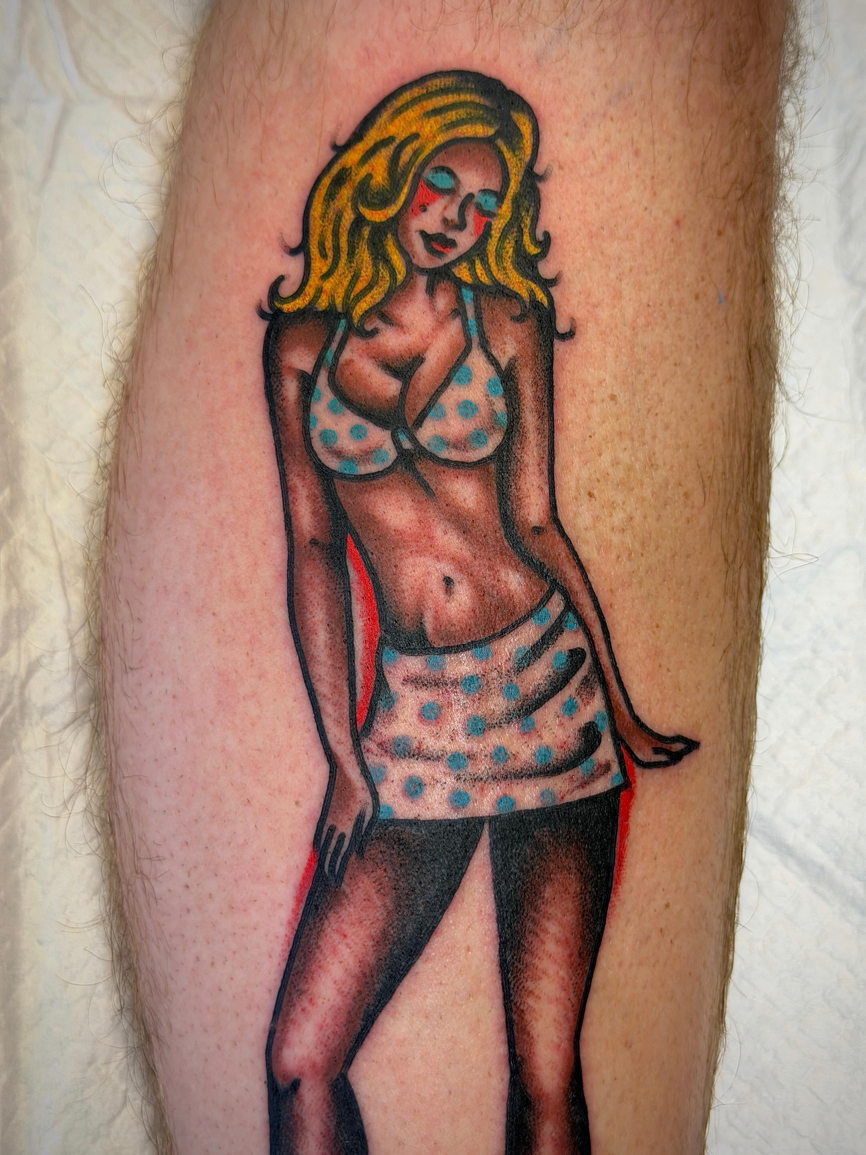 Blonde woman in polka dot outfit American traditional tattoo on the forearm by Joshua Speight