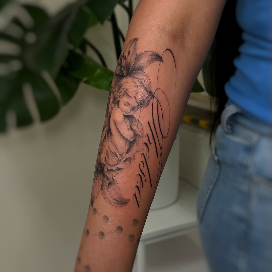 Cherub and flower with name realism tattoo on the forearm by David