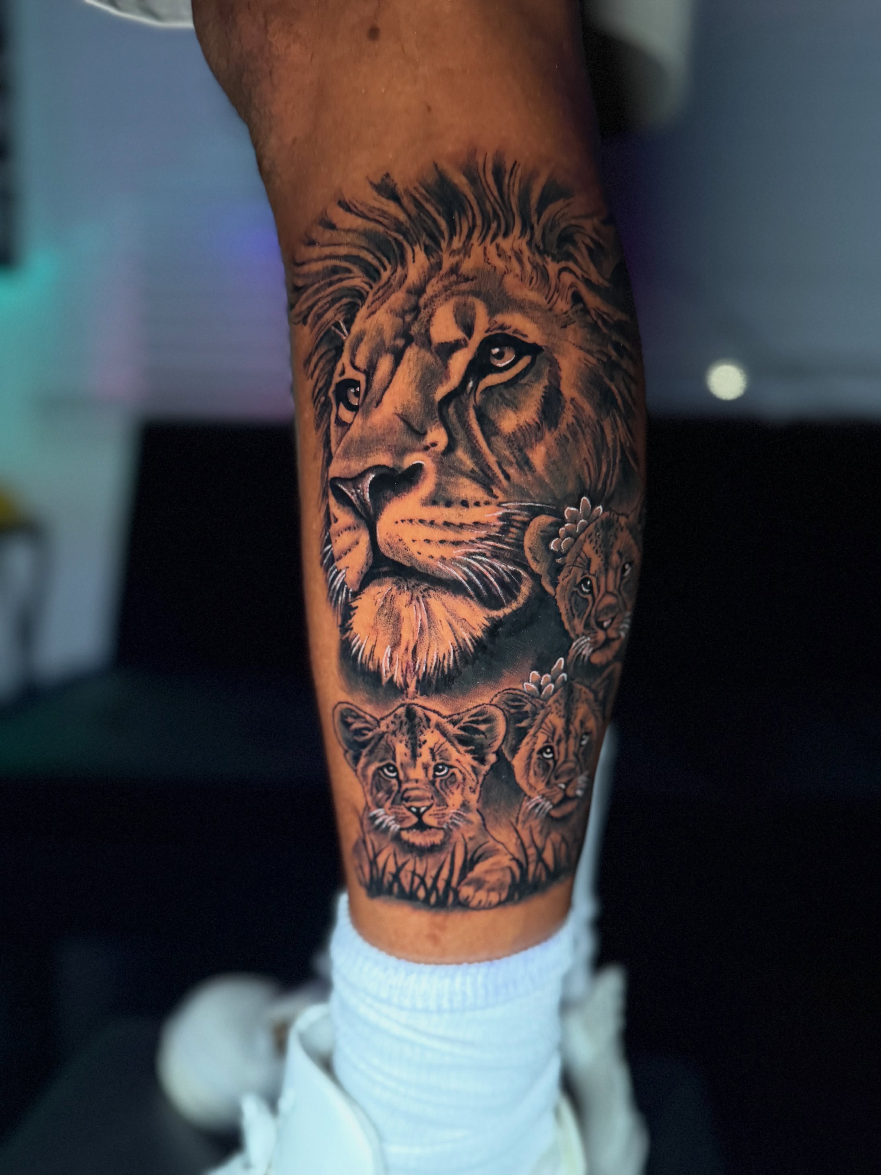 Lion family realism tattoo on the forearm by Quentin Stevenson, Slidell, Louisiana