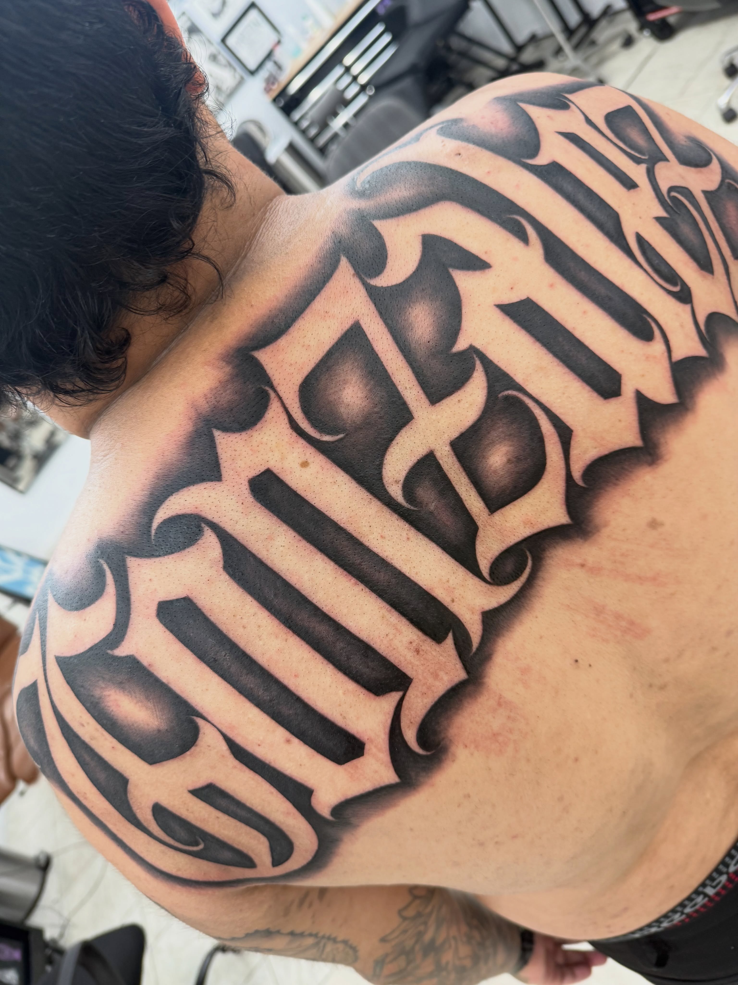 Script lettering lettering script tattoo on the back by Daniel Lopez Tattoos