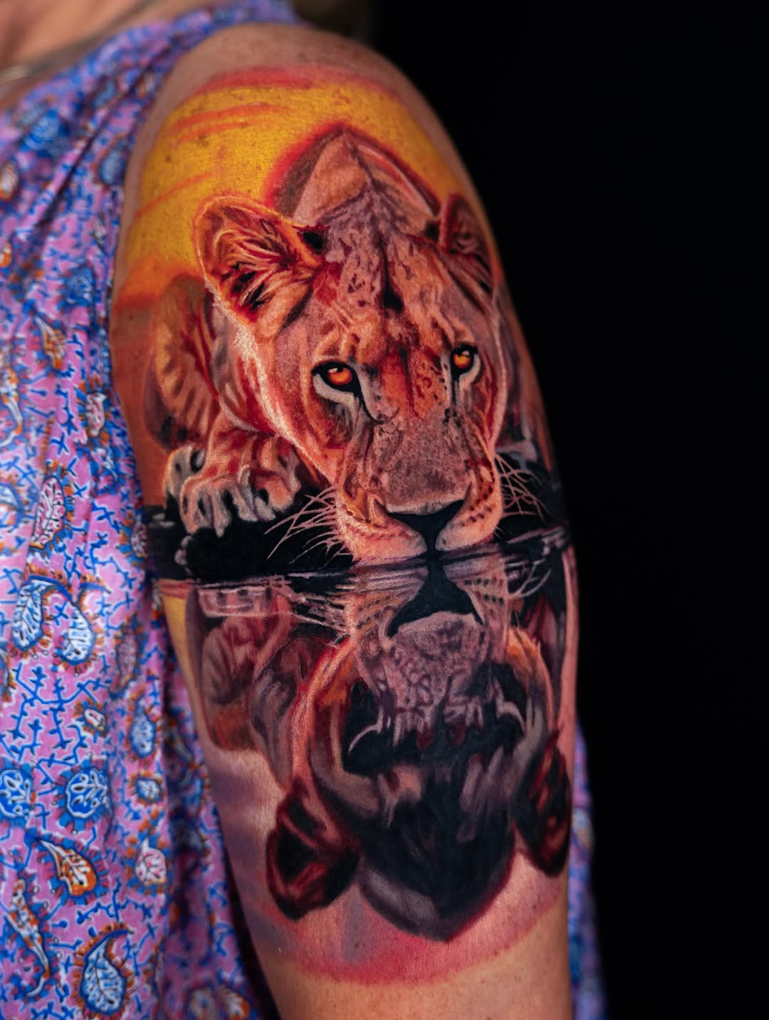 Lioness reflection realism tattoo on the upper arm by B R A D C H A R L e S