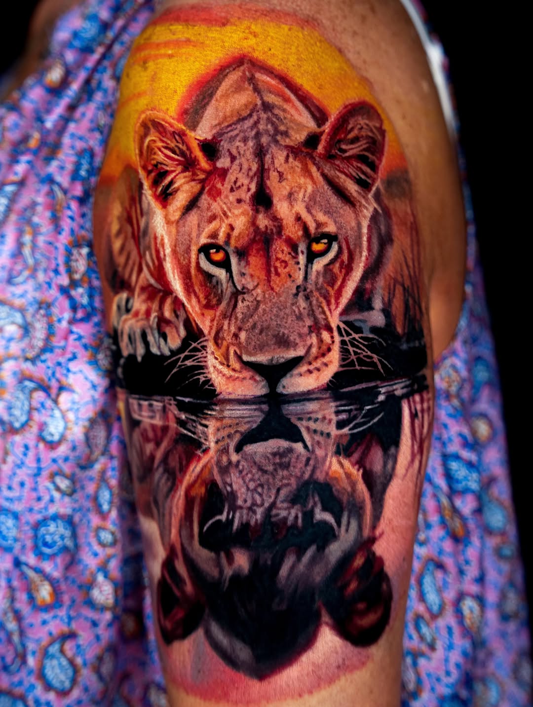 Lioness reflection at sunset realism tattoo on the upper arm by B R A D C H A R L e S