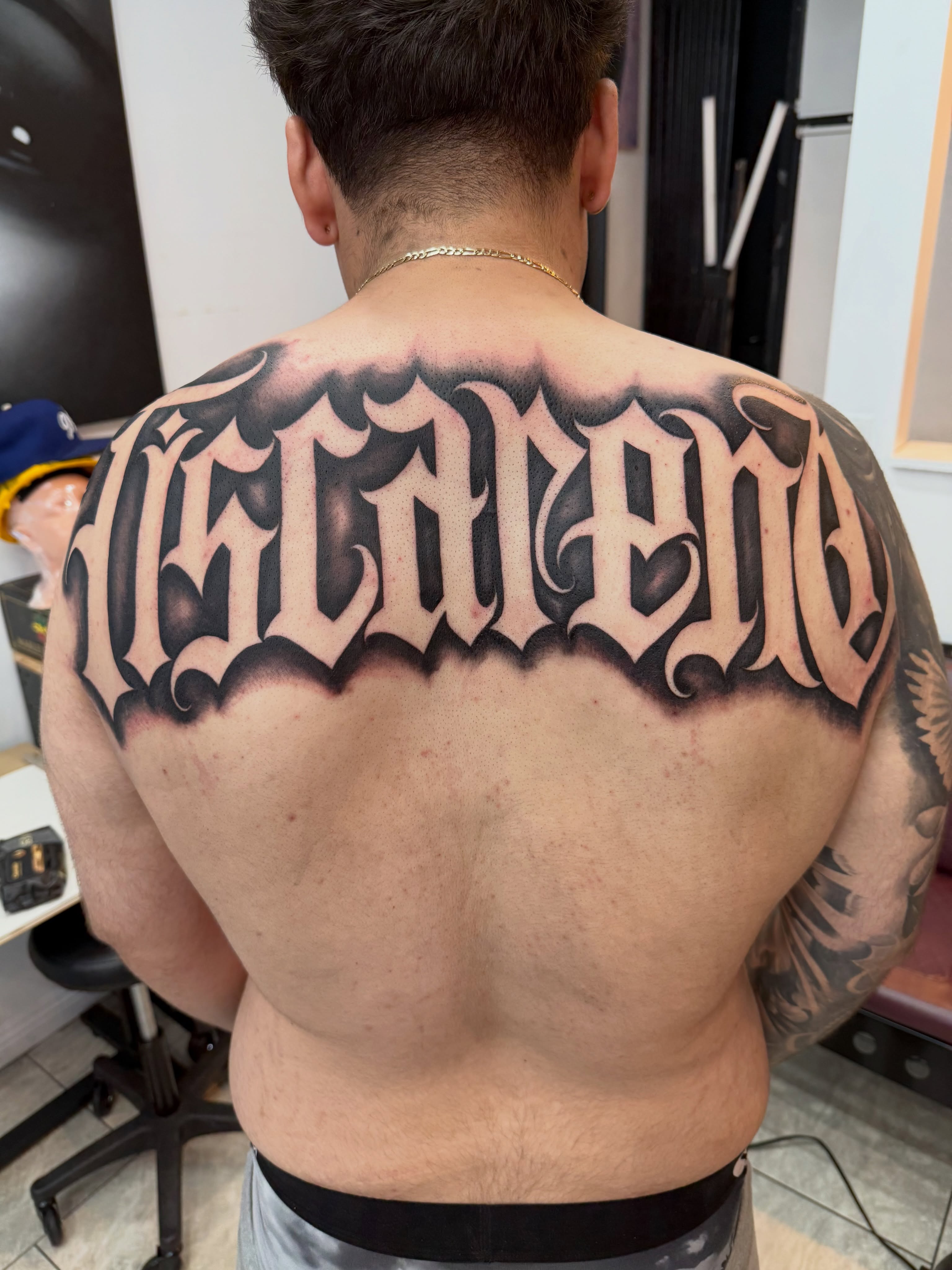 Lettering lettering script tattoo on the back by Daniel Lopez Tattoos