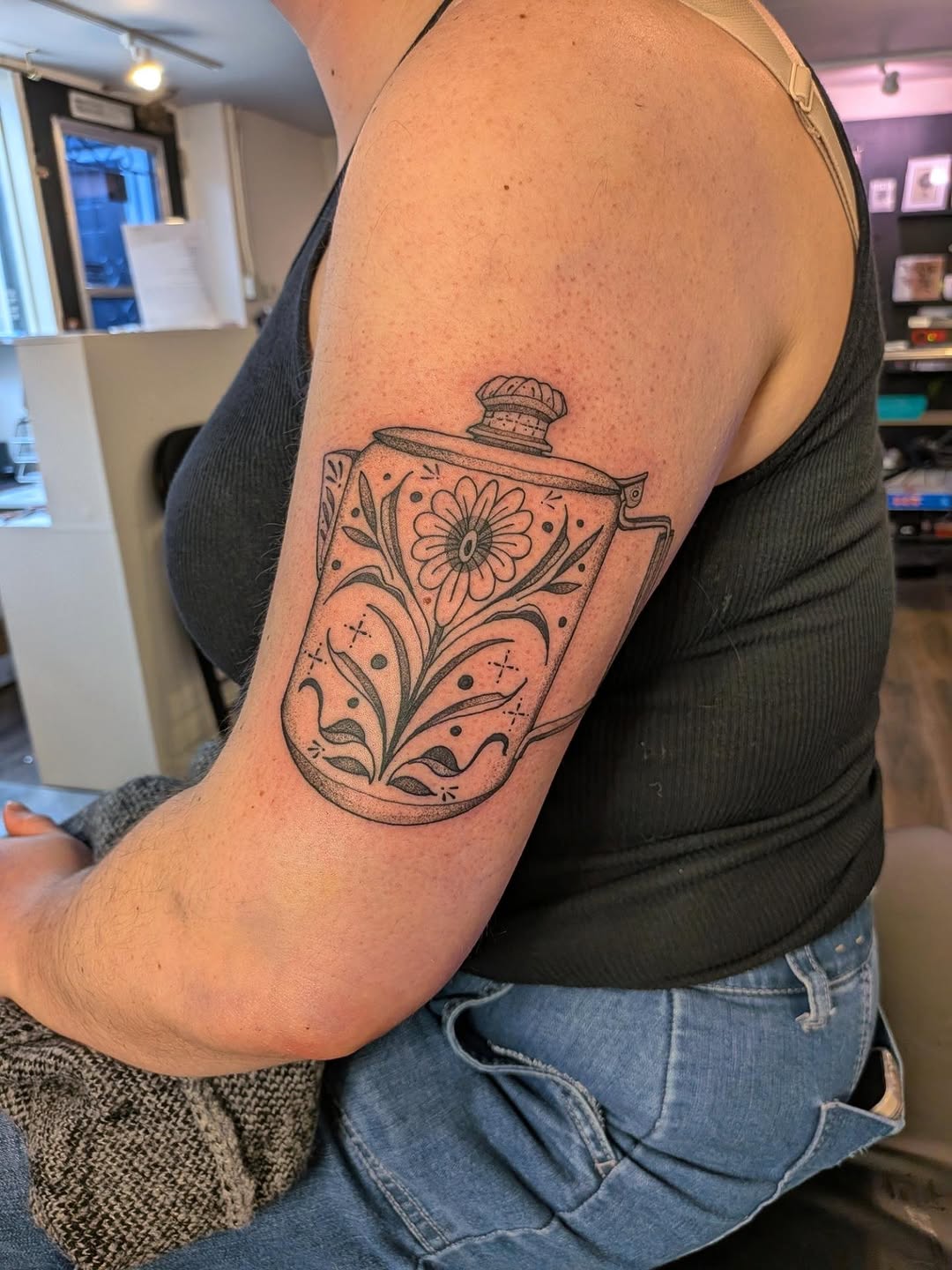 Teapot with floral design minimalist tattoo on the upper arm by šeah š¾reenwood
