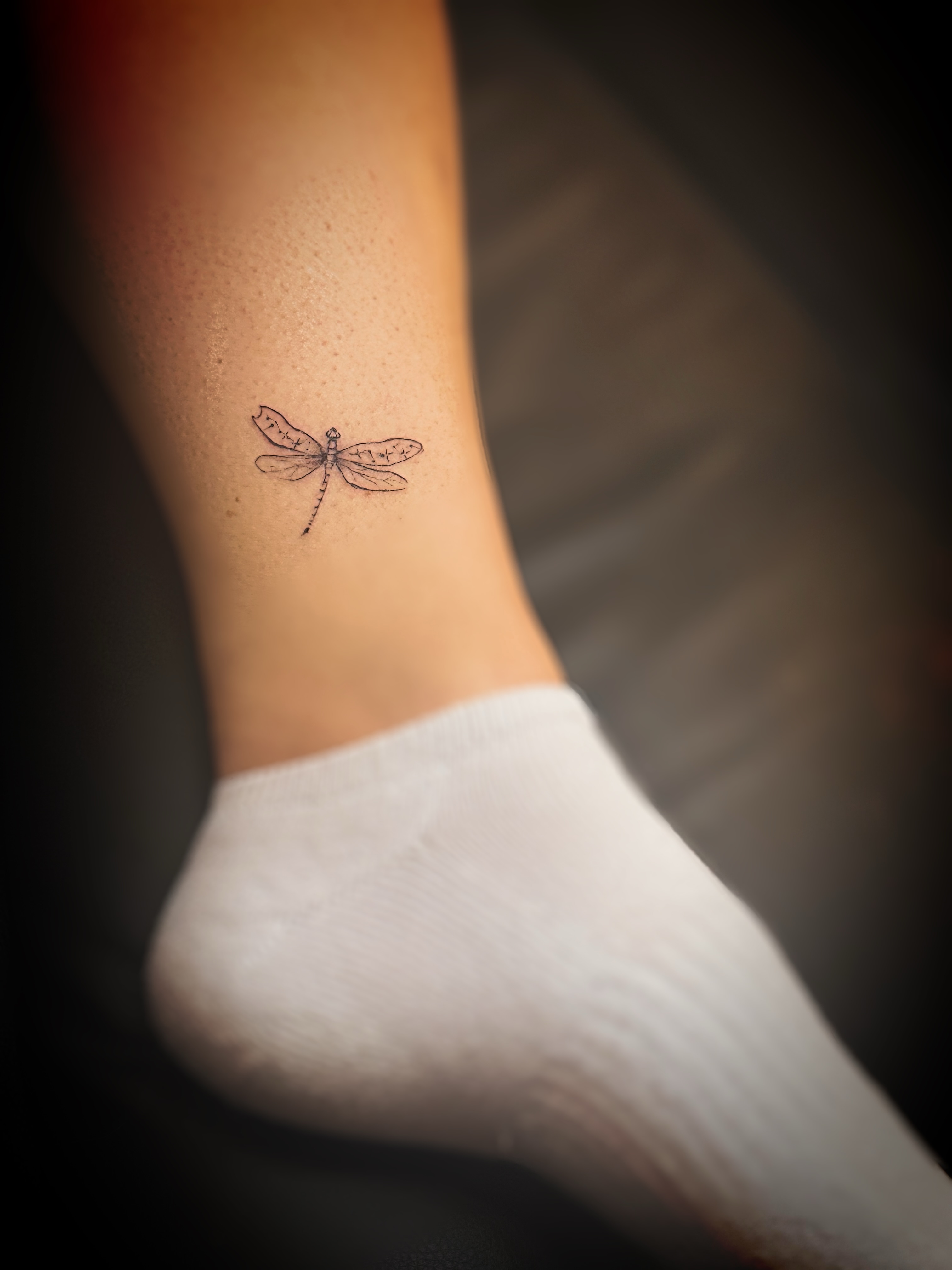 Dragonfly fine line tattoo on the leg by Meagan, Charlotte, North Carolina