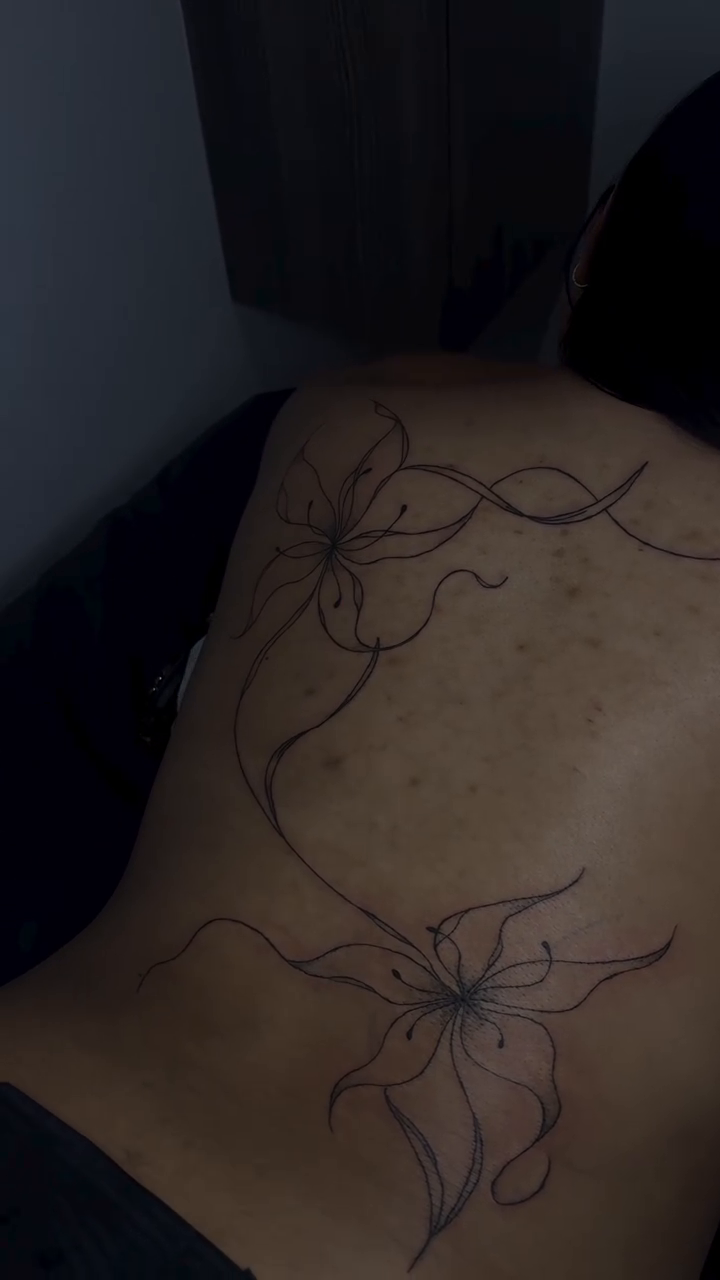 Floral vine tattoo on back blackwork tattoo on the back by Valentina