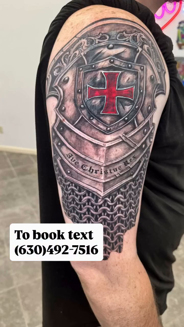 Knight's armor with a cross emblem realism tattoo on the shoulder by Juan Guzman