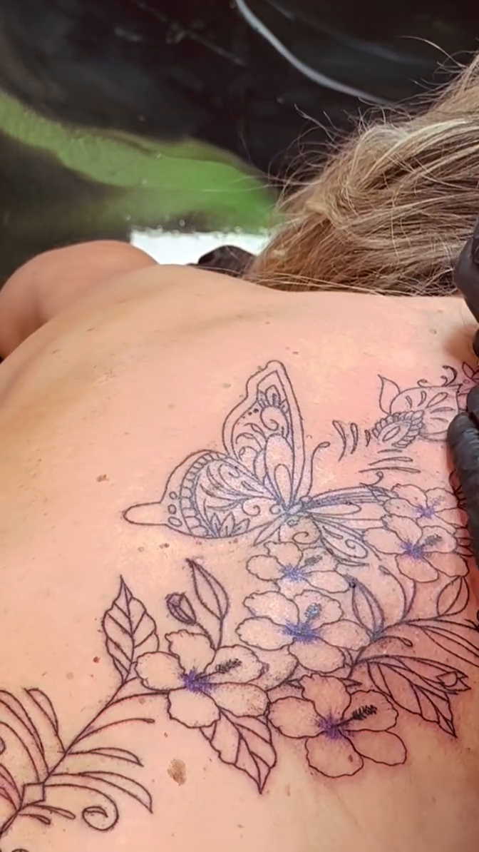Butterfly and flowers on back fine line tattoo on the back by Erik Pagtakhan