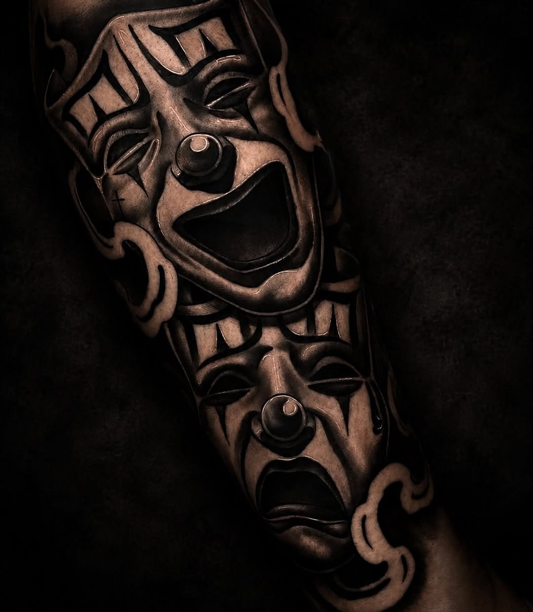 Comedy and tragedy masks realism tattoo on the forearm by @elijahtats