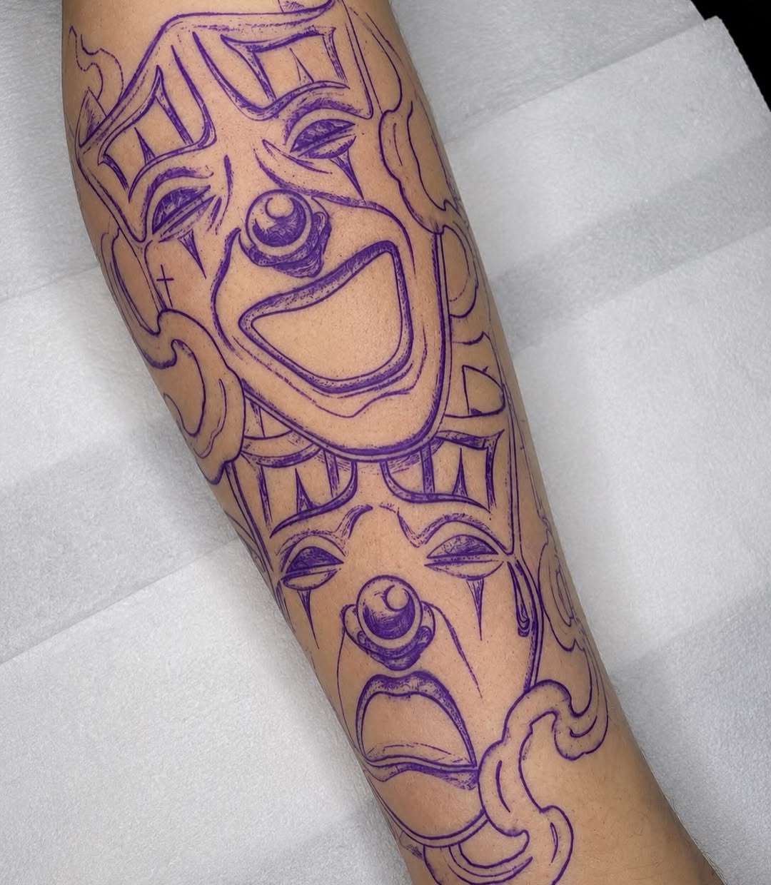 Comedy and tragedy masks realism tattoo on the forearm by @elijahtats