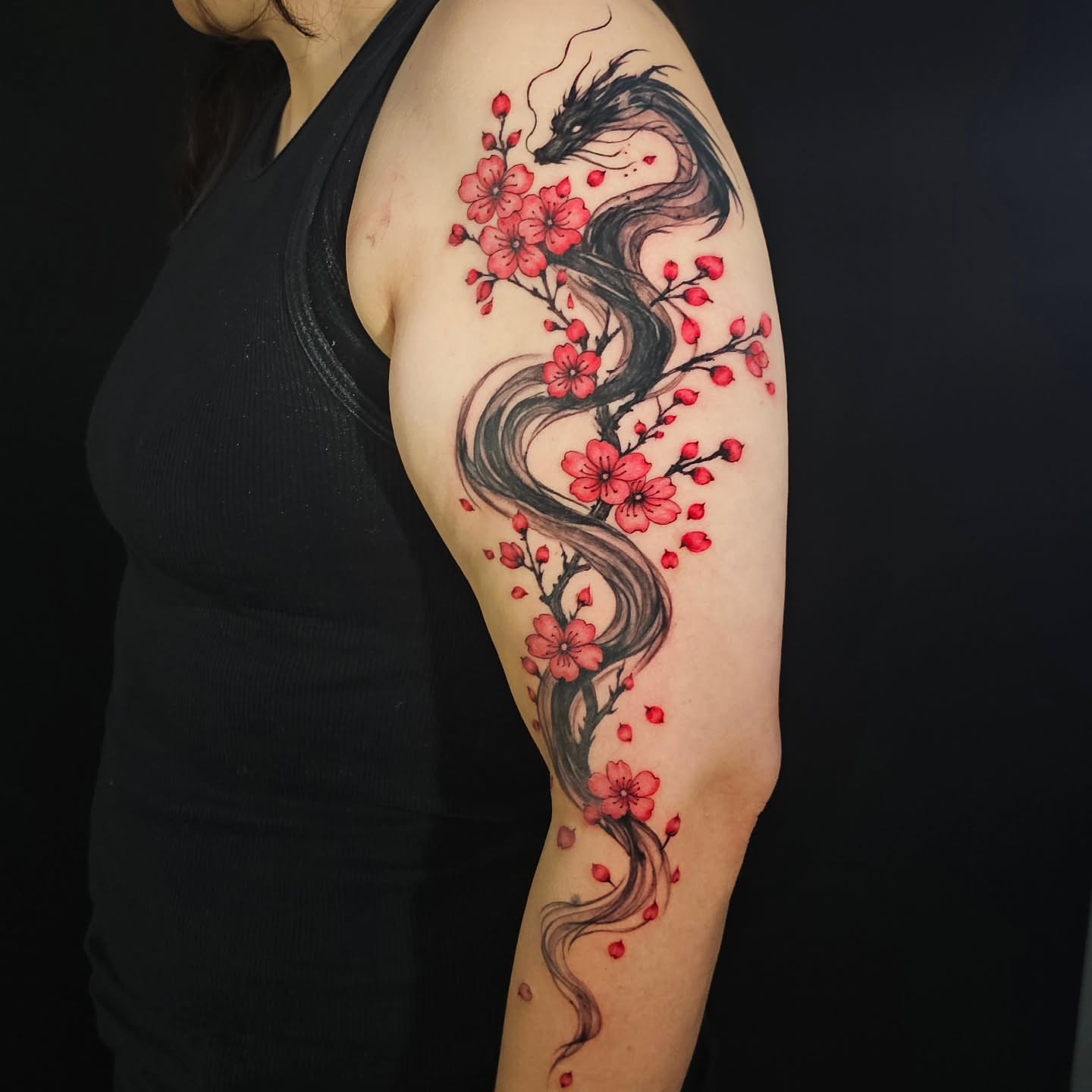 Dragon and cherry blossoms japanese irezumi tattoo on the upper arm by Lili Gu