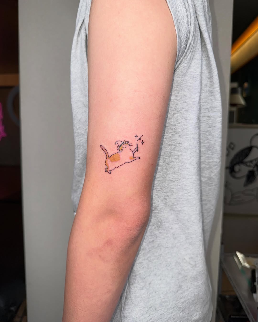 Cat with wizard hat and wand new school tattoo on the forearm by 림구타투