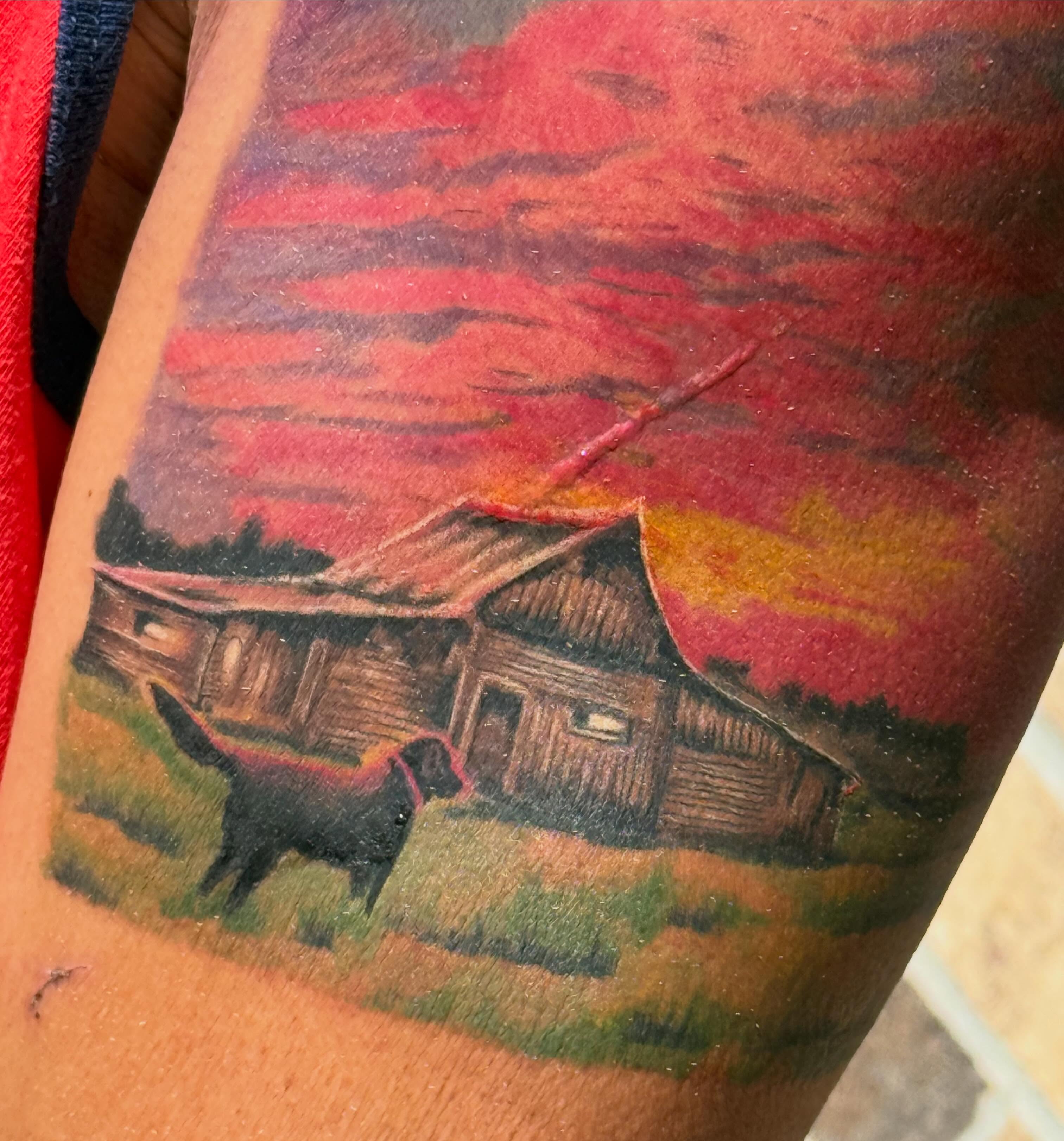Rural landscape with dog realism tattoo on the forearm by Lauren Horness