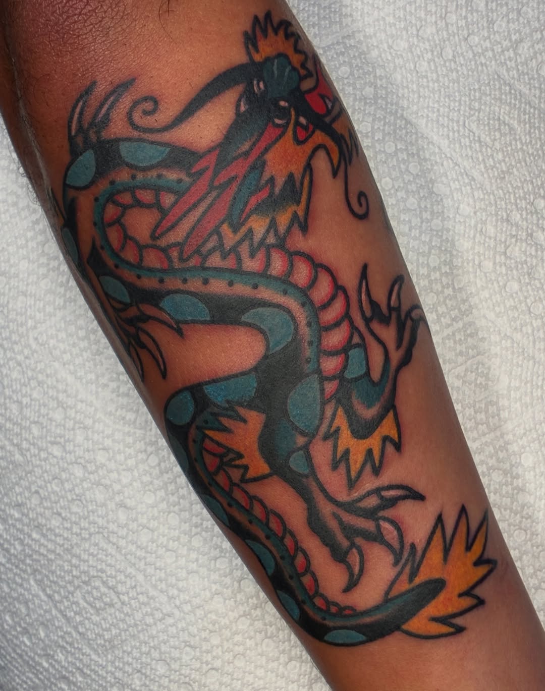 Dragon American traditional tattoo on the forearm by Sav Robinson