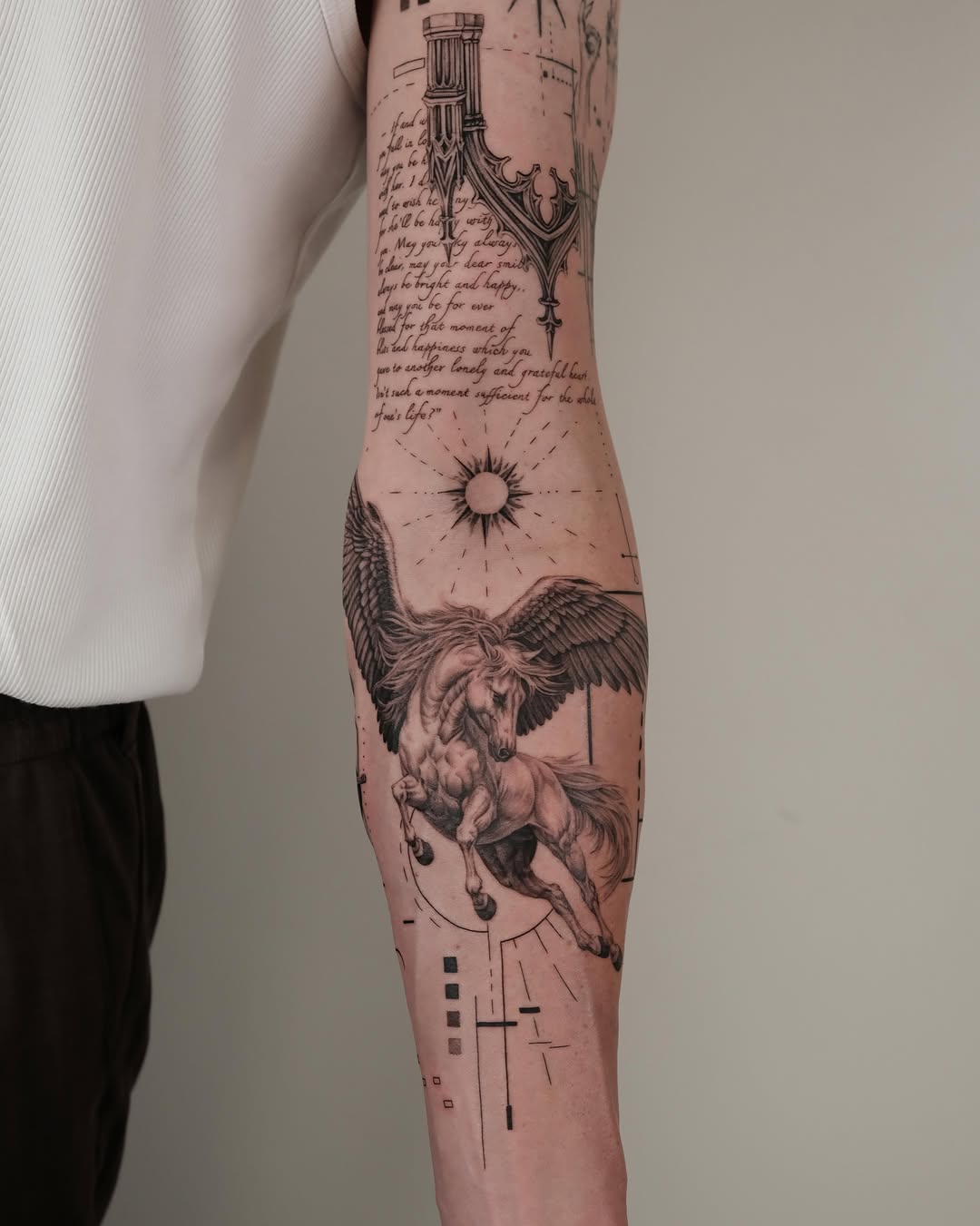 Pegasus with script and geometric elements realism tattoo on the forearm by Zay - Realistic tattoo Artist